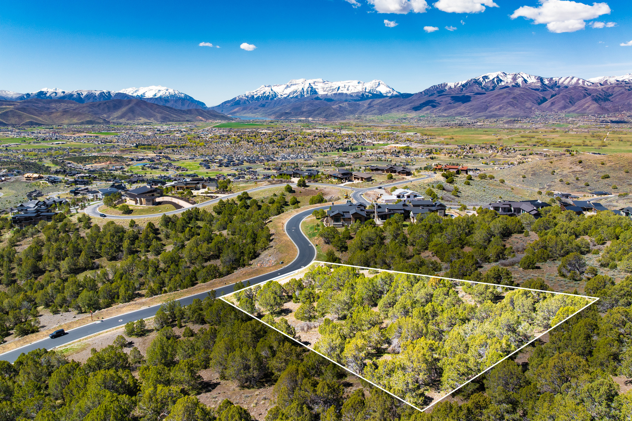 Coming in at 2.05 acres, this homesite is already sizable but lives much larger, with over an acre of open space on the northwest border and 400+ acres of protected land to the rear, creating a buffer that extends the sense of privacy well beyond the property lines. A gradual uphill slope makes for a straightforward build, with southern-facing views that look out over the Eastern Heber Valley and capture both the Uinta and Wasatch mountain ranges. Build a custom home, or explore thoughtfully designed semi-custom floor plans through the Red Ledges Construction Artisan Home Building Program. All membership categories are available, offering access to two Jack Nicklaus Signature Golf Courses, tennis and pickleball, a fitness and wellness center, equestrian facilities, two pools, and miles of trails; supporting a true four-season lifestyle.