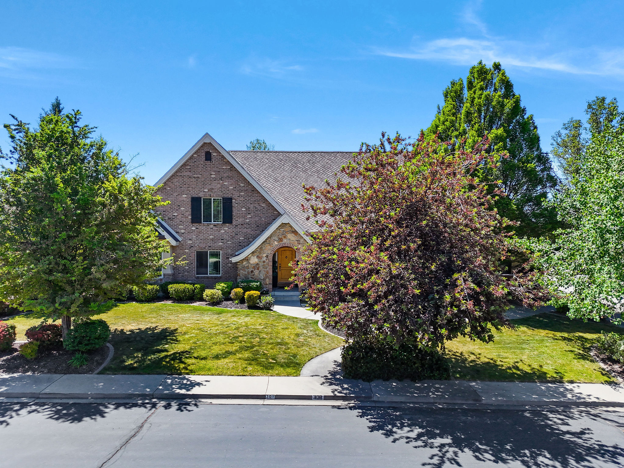 A home of this size, presence, and location doesn't come along often. Set beneath mature trees in a desirable Lindon neighborhood, this impressive brick-and-stone estate offers 8 bedrooms and 6,435 sq ft of beautifully livable space-room to host, room to breathe, and room for every season of life. The layout is built for flexibility, with multiple spaces to gather or retreat, generous bedroom sizes, and a finished basement with a private entrance-perfect for extended-stay guests, multigenerational living, or creating the ultimate theater, gym, and work-from-home setup. Outside, enjoy the feel of nearly half an acre (.46), plus the convenience of a 3-car garage and the freedom of no HOA. Located in the heart of Lindon with Alpine District schools nearby-this is the kind of home that supports big living and long-term comfort.