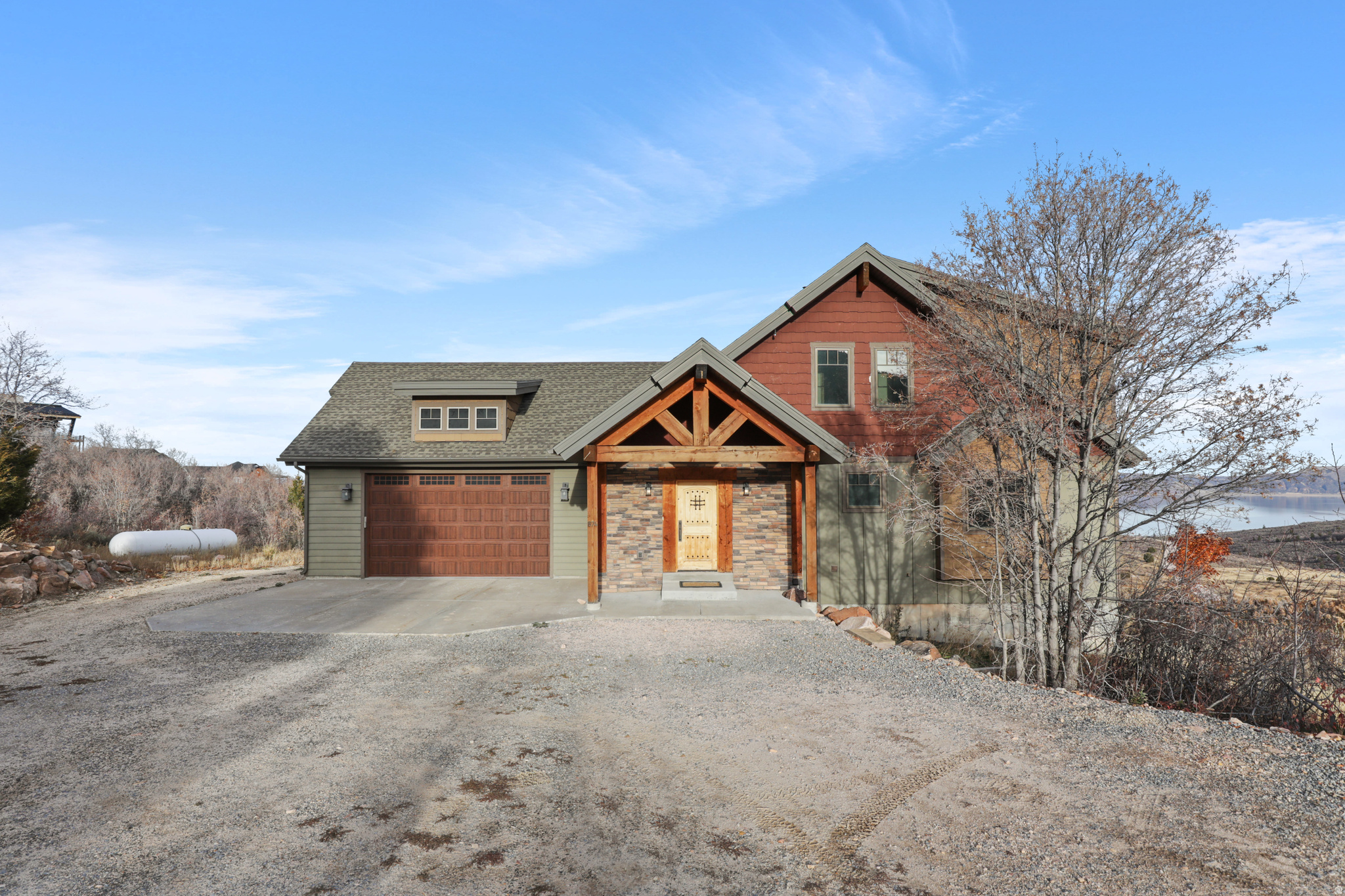 Nestled in the desirable paved subdivision of Eagle Feather at Shundahai, this beautiful Bear Lake cabin offers the perfect blend of rustic charm and modern comfort. With seven bedrooms and six bathrooms, there's plenty of room for family and guests to relax and enjoy the Bear Lake lifestyle. The open kitchen, dining, and great room showcase stunning rustic arched beams and flow seamlessly onto two covered decks-ideal for taking in the breathtaking Bear Lake sunrises and sunsets. The main floor features a spacious master suite, while the upper level includes a cozy kids' loft with a TV area, bathroom, and bunk room. Step outside to a large stamped concrete patio complete with a firepit and a covered kids' sand area overlooking the lake, and just below, a fun playground awaits. The lower level offers a spacious family and game room with a full wet bar and a massive theater room, perfect for entertaining. Five additional bedrooms and three bathrooms complete the lower level, providing ample space for everyone. Located just five minutes from Bear Lake State Park Marina and fifteen minutes from Beaver Mountain Ski Resort, this home also offers easy access to the trail system leading into Cache National Forest for ATV/UTV riding, snowmobiling, hiking, and mountain biking. Short-term rentals are allowed, making this an exceptional opportunity for both personal enjoyment and investment.