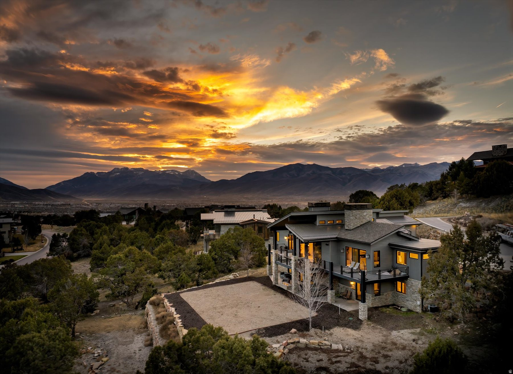 Experience breathtaking views of Heber Valley and the Wasatch Mountains from this stunning modern mountain retreat along the coveted Explorer Peak Drive within the private gates of Red Ledges. Designed for seamless indoor-outdoor living, the open-concept floor plan features panoramic sliding glass doors, a dramatic double-sided fireplace, and a chef's kitchen with custom cabinetry, waterfall island, plus expansive butler's pantry. All five bedrooms offer luxurious en-suite baths and custom walk-in closets, while the private primary suite showcases a beautiful plaster fireplace. The walkout lower level is built for entertaining with a spacious gathering area, wet bar, stone fireplace, and custom bunk room. Enjoy expansive decks, elevated outdoor spaces, and access to Red Ledges' world-class golf, tennis, fitness, equestrian, and Deer Valley partnerships. This one is worth a peak,  schedule your private showing today!