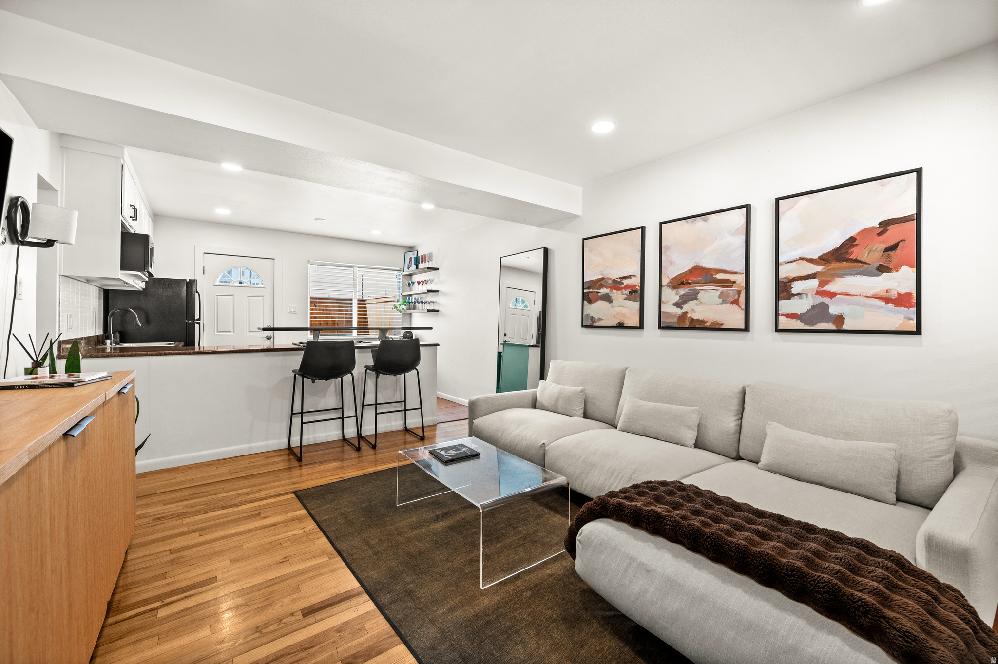 This is a one-of-a-kind condo tucked into the historic Marmalade District - where charm, character, and convenience meet. What truly sets this home apart is its rare private patio with direct access, a peaceful retreat right in the city. The south-facing patio enjoys abundant natural light throughout the day, and has been beautifully updated with new fencing and decking, perfect for a dog owner, gardener, or outdoor chef. Inside, you'd find original hardwood floors, new recessed lighting, updated water heater and HVAC (2020-2021), added insulation in ceilings and interior walls, and a custom wood-slat acoustic wall in the primary bedroom. The bright and updated kitchen features a gas range and generous counter space, and the in-unit laundry adds everyday convenience. Walk to neighborhood favorites like Marmalade Brunch House, Taverna Pizza, Salt Lake Acting Company, and the beautiful new City Library. Stroll to the State Capitol or Warm Springs Park, or enjoy quick access to the freeway and downtown Salt Lake City. Marmalade Square has a great sense of community and features gated parking, additional storage, a pool & hot tub, fitness center, and dog park. Don't miss this hidden gem in one of Salt Lake City's most desirable neighborhoods.