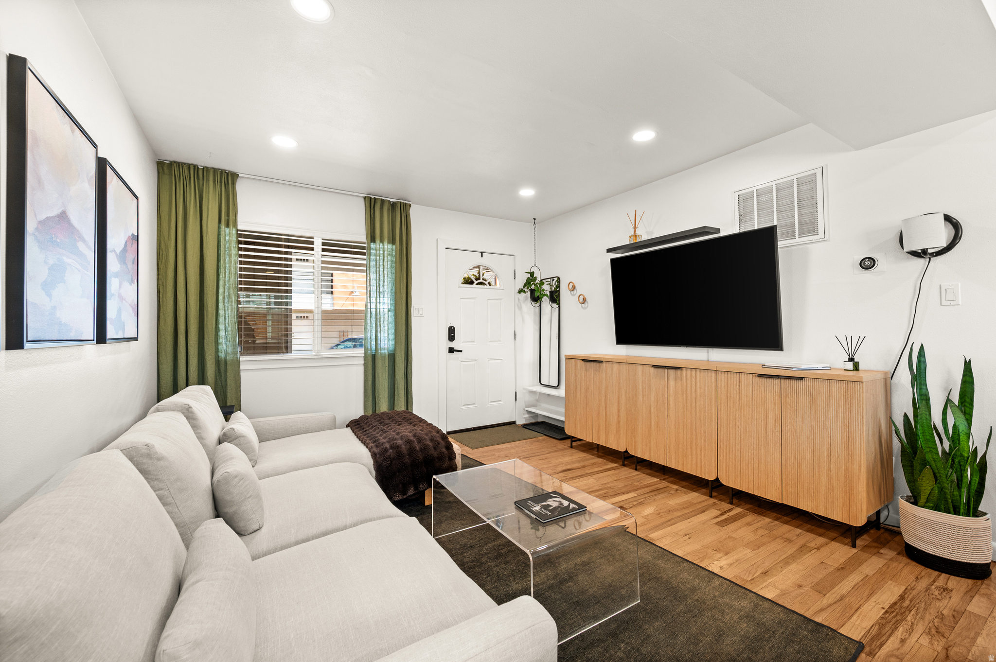 This is a one-of-a-kind condo tucked into the historic Marmalade District - where charm, character, and convenience meet. What truly sets this home apart is its rare private patio with direct access, a peaceful retreat right in the city. The south-facing patio enjoys abundant natural light throughout the day, and has been beautifully updated with new fencing and decking, perfect for a dog owner, gardener, or outdoor chef. Inside, you'd find original hardwood floors, new recessed lighting, updated water heater and HVAC (2020-2021), added insulation in ceilings and interior walls, and a custom wood-slat acoustic wall in the primary bedroom. The bright and updated kitchen features a gas range and generous counter space, and the in-unit laundry adds everyday convenience. Walk to neighborhood favorites like Marmalade Brunch House, Taverna Pizza, Salt Lake Acting Company, and the beautiful new City Library. Stroll to the State Capitol or Warm Springs Park, or enjoy quick access to the freeway and downtown Salt Lake City. Marmalade Square has a great sense of community and features gated parking, additional storage, a pool & hot tub, fitness center, and dog park. Don't miss this hidden gem in one of Salt Lake City's most desirable neighborhoods.