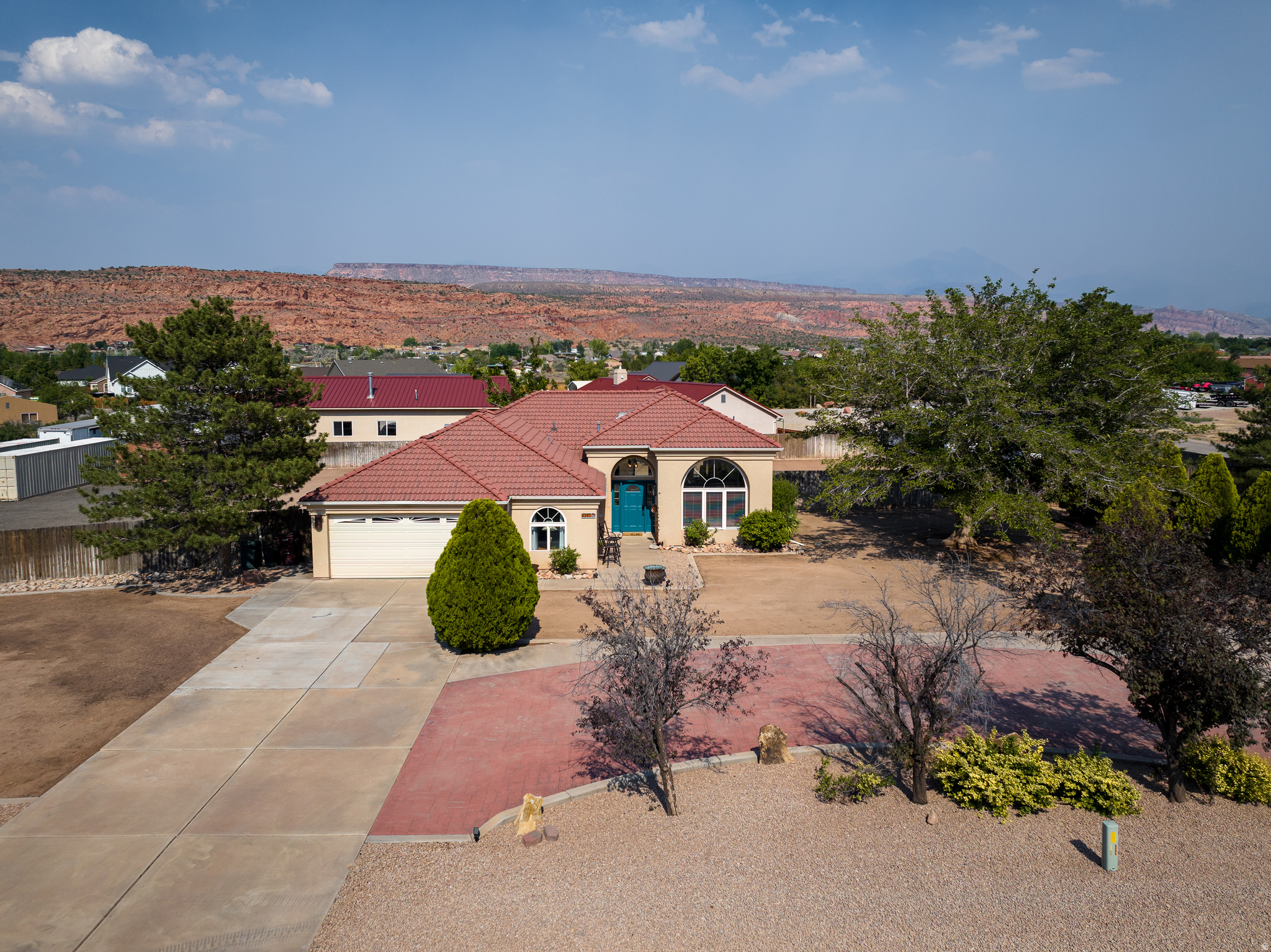 Nestled on a full acre with breathtaking views of both the iconic red rock formations and the majestic La Sal Mountains, this beautifully remodeled 4-bedroom, 2-bath home offers the perfect blend of comfort, style, and space. Step inside to an inviting open floor plan designed for modern living and effortless entertaining. The heart of the home is the stunning custom kitchen, featuring gorgeous granite countertops, abundant custom cabinetry for exceptional storage, and a large center island that serves as the perfect gathering place for family and friends. Expansive windows bring the surrounding scenery indoors, allowing you to enjoy the spectacular views from the main living areas. The spacious layout provides comfortable bedrooms, updated finishes throughout, and a seamless flow between the kitchen, dining, and living spaces. Outside, the one-acre property offers endless possibilities for outdoor living, recreation, gardening, or future expansion while taking full advantage of the incredible mountain and red rock vistas. Whether you're looking for a primary residence, vacation retreat, or investment opportunity, this move-in-ready home combines modern updates with the natural beauty that makes the Moab area so desirable.
