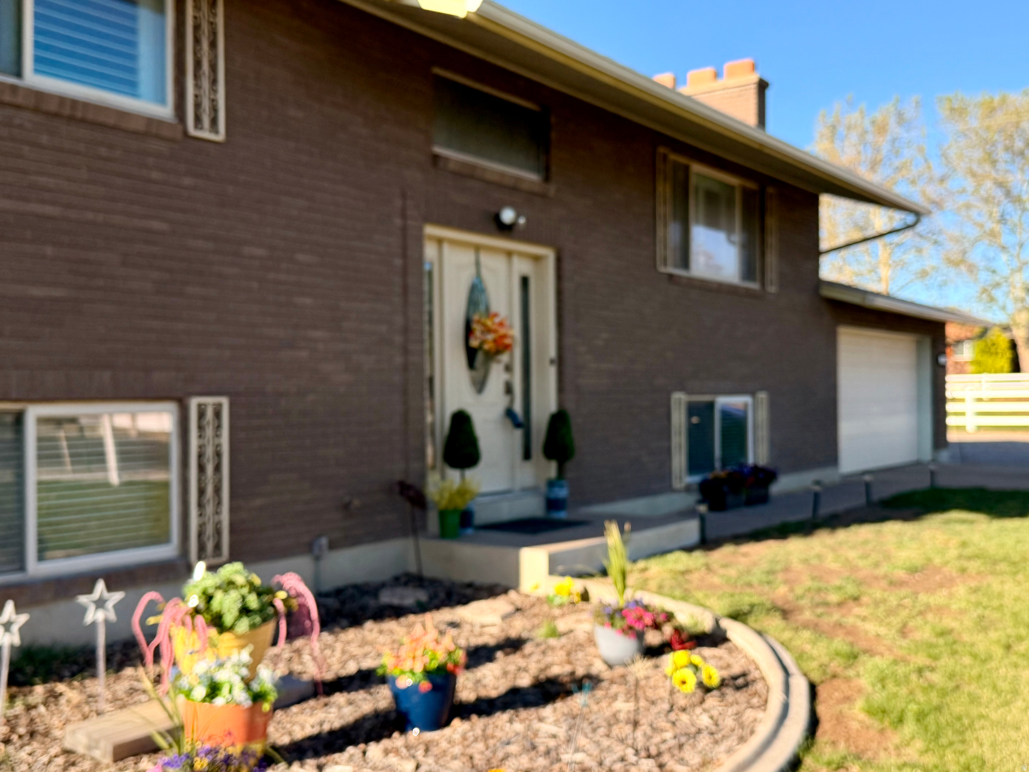 Motivated seller! Rare 0.77-acre Clinton property with the space and flexibility you've been searching for. Features an impressive 4,536 sq ft multi-use building with power, office space, and water-perfect for a workshop, business, storage, hobbies, or projects. Plus a 1,600 sq ft covered structure with two-story clearance ideal for RVs, trailers, boats, or equipment.  The fully finished brick home offers generous living space, a separate basement entrance, covered deck, patio, gazebo, and recent updates including a new water heater and expansion tank. Attached garage includes its own furnace and thermostat for year-round workspace potential.  Conveniently located near parks, shopping, dining, and Hill Air Force Base. Rare opportunity with room to build, store, work, and play-now offered at $625,000.