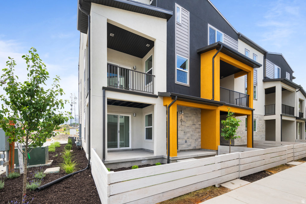 LOCATION can't be beat in this ideally located community! Whether you enjoy biking along the Jordan River Trail just blocks away, taking an evening stroll through nearby parks, walking the kids to school, or simply having shopping, dining, and everyday essentials within minutes, you'll appreciate how easy it is to enjoy everything the Salt Lake Valley has to offer. With quick access to I-15 and I-215, commuting to downtown Salt Lake City, the airport, or anywhere across the valley is simple and convenient.  This sought-after end-unit townhome is filled with natural light thanks to windows on three sides and offers multiple outdoor spaces, including a fenced front yard, oversized patio, and private balcony-perfect for morning coffee, entertaining guests, or unwinding at the end of the day while enjoying mountain views.  Inside, the open-concept design features spacious living areas and a stylish kitchen with modern dark gray cabinetry, creating a comfortable setting for everyday living and special gatherings alike. Energy-efficient features, solar-ready wiring, instant hot water, and a private garage with an EV outlet provide modern convenience and long-term savings.  Residents also enjoy community green space, a playground, BBQ gathering area, and ample guest parking. Combining comfort, convenience, and a location that keeps you connected to both recreation and daily necessities, this home offers a lifestyle that's easy to love.