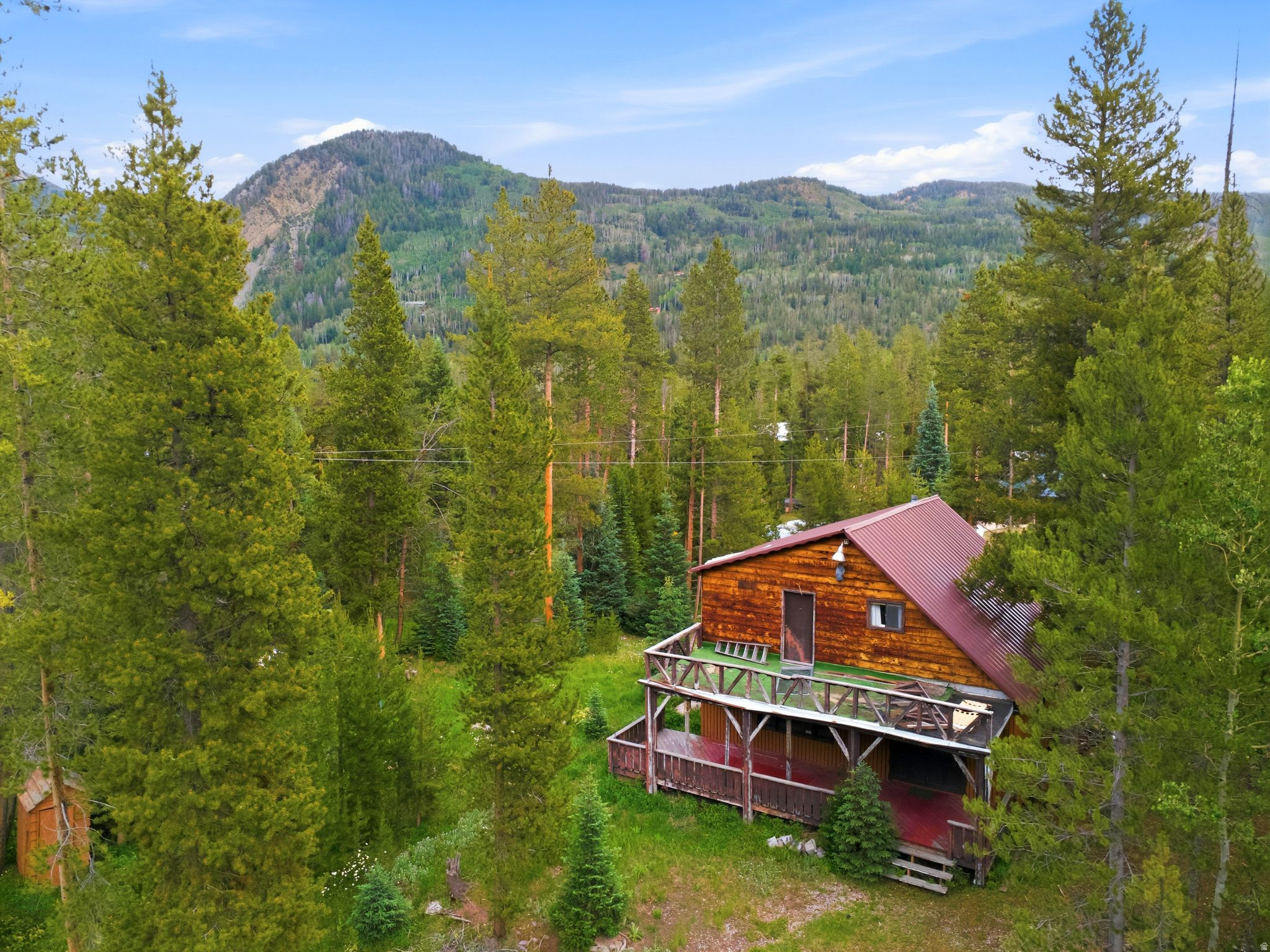 Presenting a rarely available cabin ownership opportunity at the top of Weber Canyon in the coveted Alpine Acres community. This property encompasses two lots totaling 2.4 acres bordering Gardner Fork with a 1,605 square foot cabin packed with character. The parcels are both very flat providing the option of future expansion, additional building, enjoying as is or taking advantage of the potential of this cabin and bringing it back to the shape it once was. The setting is nearly unbeatable, from listening to the creek bordering the property, the frequent visits from the local wildlife, stunning views of the High Uinta mountains in every direction and endless recreation opportunities directly out the door. This is a fantastic opportunity that is not to be overlooked.   Square footage figures are provided as a courtesy estimate only .  Buyer is advised to obtain an independent measurement.