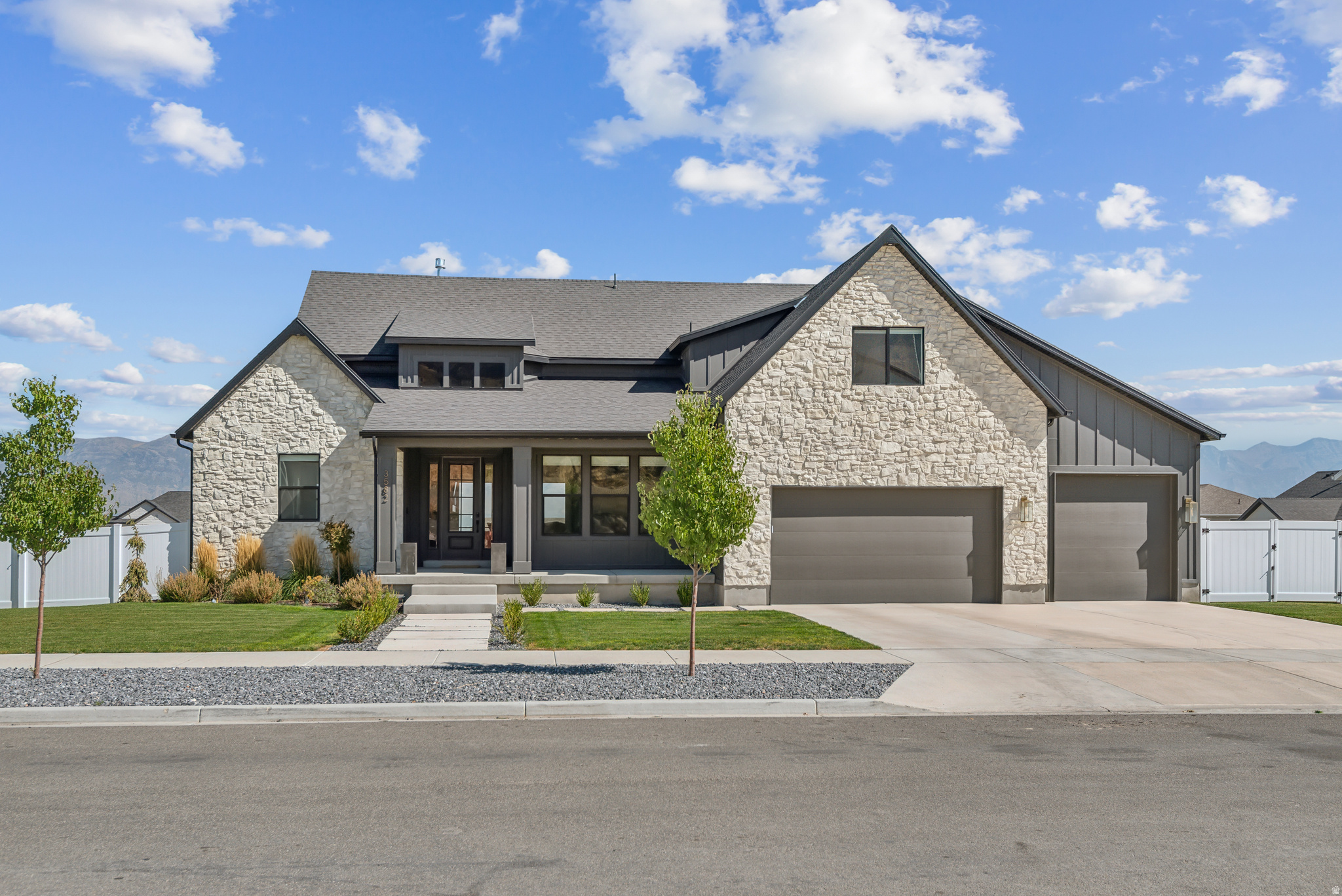 This stunning custom home offers breathtaking views and a thoughtfully designed layout that blends comfort, functionality, and elevated finishes throughout. The main-level primary suite features a vaulted ceiling, a beautifully designed custom bathroom with a separate shower and soaking tub, and an expansive walk-in closet - large enough to accommodate a stackable washer and dryer, already plumbed and vented for convenience. The main level showcases 8' doors, durable LVT flooring, ceilings ranging from 9' to 16', and custom lighting that adds warmth and sophistication throughout the space. Designed with both beauty and function in mind, the kitchen is a true centerpiece. It features KitchenAid appliances, including double wall ovens and a gas cooktop, along with a spacious 9' x 5' island. Quartz countertops extend seamlessly into the backsplash for a clean, modern finish without grout lines. Custom cabinetry throughout the home includes thoughtful details such as built-in spice racks and abundant storage. Additional highlights include a custom mudroom with five oversized lockers, providing exceptional organization and everyday functionality. This beautifully crafted home offers a rare combination of custom design, quality finishes, and incredible views.