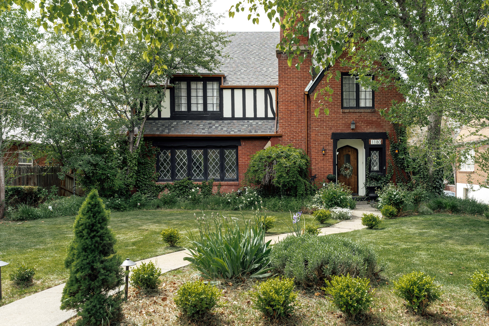 Set within the heart of Harvard/Yale, this beautifully updated 1926 Tudor feels especially magical in spring-when sunlight pours through the leaded glass windows, mature trees begin to bloom, and the backyard becomes an extension of the home itself. Rich original woodwork, graceful architectural lines, handmade tile details, and curated lighting create a warmth that feels both timeless and inviting, while thoughtful modern updates bring comfort and ease to everyday living. Inside, the home offers more than 4,000 square feet with five bedrooms, four bathrooms, and spaces designed for both gathering and retreat. The beautifully reimagined primary suite feels serene and spacious, complete with a large walk-in closet and updated ensuite bath-an uncommon luxury in a Tudor of this era. Downstairs, the fully finished walkout lower level includes two additional bedrooms, a full bath, and a second kitchen, creating flexibility for guests, multigenerational living, or income potential. Out back, the rare flat backyard unfolds like a private sanctuary in the city. A custom outdoor fireplace anchors the patio for cozy evenings under caf lights, while a charming fountain draws birds in and adds a quiet sense of calm. There's room to garden, gather, dine, and simply enjoy the beauty of the season. Above the detached two-car garage, a stunning vaulted finished space currently serves as a light-filled office but could easily become a studio, guest retreat, creative space, or future ADU. Located just moments from East High, beloved neighborhood cafs, 15th and 15th, and downtown Salt Lake, this home offers the rare combination of historic character, modern functionality, and one of the city's most treasured neighborhoods. Because homes like this are about more than architecture alone-they're about the life unfolding within them. Spring dinners on the patio. Windows open to the breeze. Gatherings around the fire. And the enduring beauty of a home that has been thoughtfully loved for nearly a century.