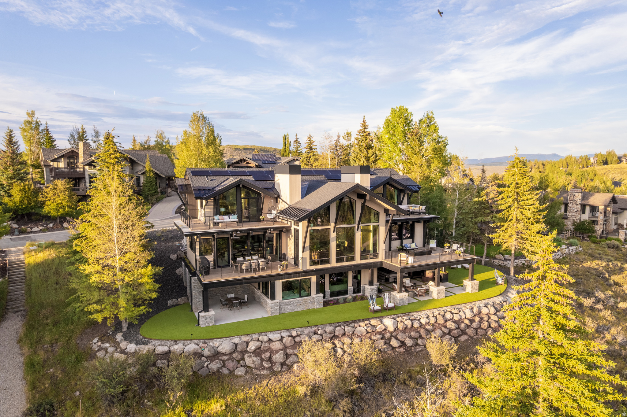 Larkspur No. 2580  Set within the coveted West Ridge neighborhood of Park Meadows, this architecturally reimagined 5-bedroom, 5-bath Park City luxury home captures panoramic Deer Valley, Park City Mountain, and Wasatch Range views from a private cul-de-sac setting. Comprehensively reconstructed and thoughtfully designed, this custom contemporary residence blends timeless architecture, exceptional craftsmanship, and refined mountain living just minutes from Historic Main Street, Deer Valley Resort, Park City Mountain Resort, Park Meadows Country Club, world-class golf, hiking, biking, shopping, and dining.  Thoughtfully composed around natural light, mountain views, and effortless livability, the home features soaring ceilings, dramatic walls of glass, custom rift white oak cabinetry, artisan stone, architectural steel accents, and a curated palette of designer finishes. The chef's kitchen is appointed with premium professional appliances, bespoke cabinetry, statement stone surfaces, expansive islands, and seamless connection to the dining room, great room, and covered outdoor living spaces. The private primary suite offers a spa-inspired retreat with a steam shower, custom wardrobe spaces, and breathtaking views, while generous guest suites and multiple gathering spaces provide exceptional comfort for family and guests.   Outdoor living is equally intentional, featuring multiple entertaining spaces and a private wellness retreat with an outdoor fitness area, hot tub, sauna, and cold plunge. Far beyond a traditional remodel, nearly every aspect of the home was reimagined, from the floor plan and structural systems to expansive new glazing, premium mechanical systems, custom millwork, luxury fixtures, and meticulously crafted interior and exterior finishes. Electronic upgrades include pre-wired Cat 5, a full Lutron system installed as well as Sonos for home audio. The result is a timeless contemporary residence that seamlessly blends architecture, craftsmanship, wellness, and modern mountain living in one of Park City's most sought-after neighborhoods.