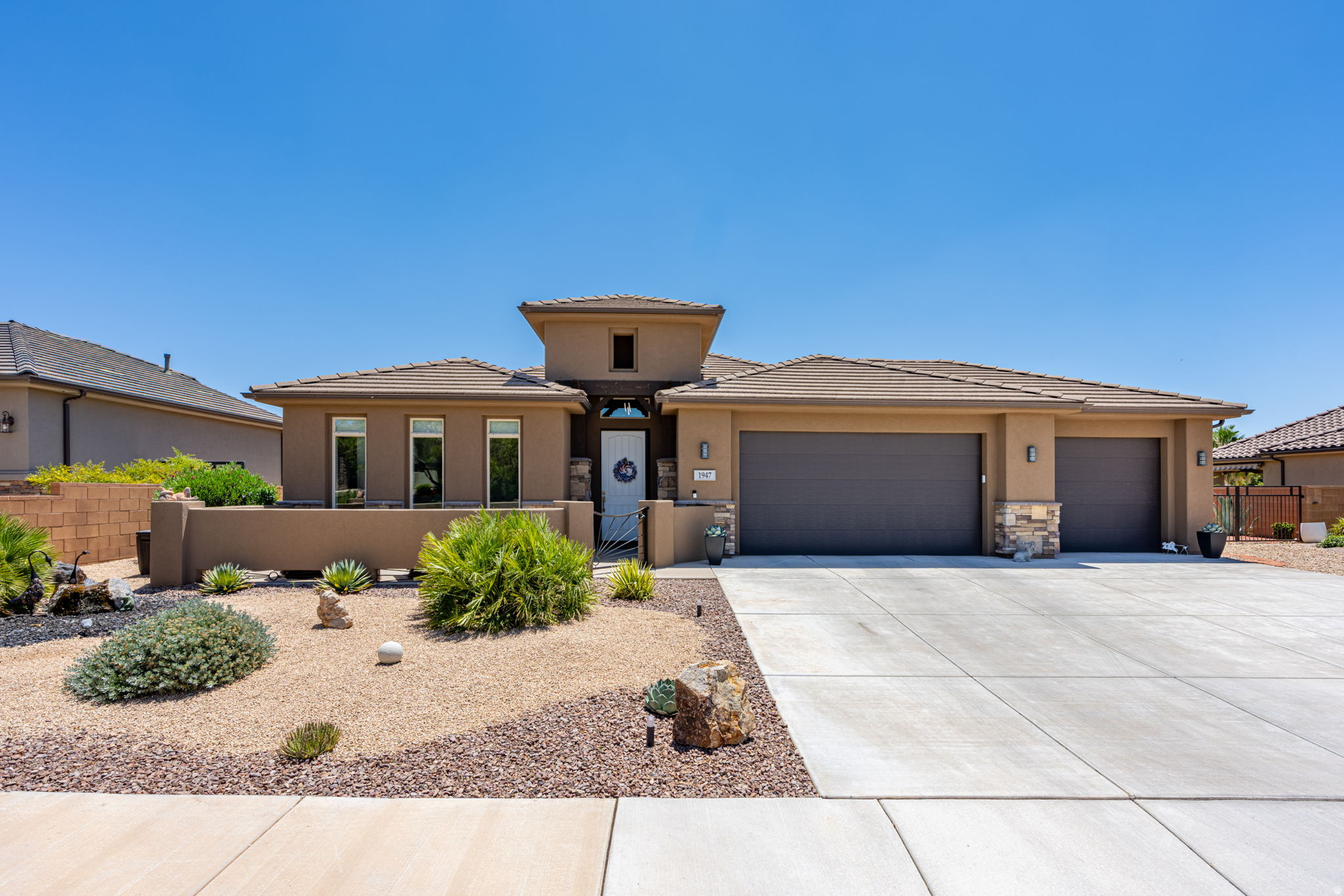 Welcome to this beautifully updated home offering modern style, thoughtful upgrades, and exceptional curb appeal. A charming front courtyard and two tranquil water features create a warm welcome before you step inside to a bright, open floor plan filled with natural light. The spacious family room is anchored by a stunning tiled accent wall featuring a sleek electric fireplace and floating shelves, creating a sophisticated focal point. The kitchen is appointed with granite countertops, knotty alder cabinetry, abundant workspace, and durable luxury vinyl plank flooring. Beautifully remodeled bathrooms featuring updated tile, fixtures, and new toilets. Enjoy relaxing under the covered back patio, or entertain in the low-maintenance, fully desert-scaped backyard complete with an additional side sitting area perfect for cornhole or outdoor gatherings. Additional highlights include a mini-split A/C in the garage, water conditioning system, and the washer, dryer, and refrigerator are all included. Conveniently located in a friendly neighborhood near shopping, schools, medical facilities, golf, and everyday amenities, this move-in-ready home truly has it all. Optional furniture package available.