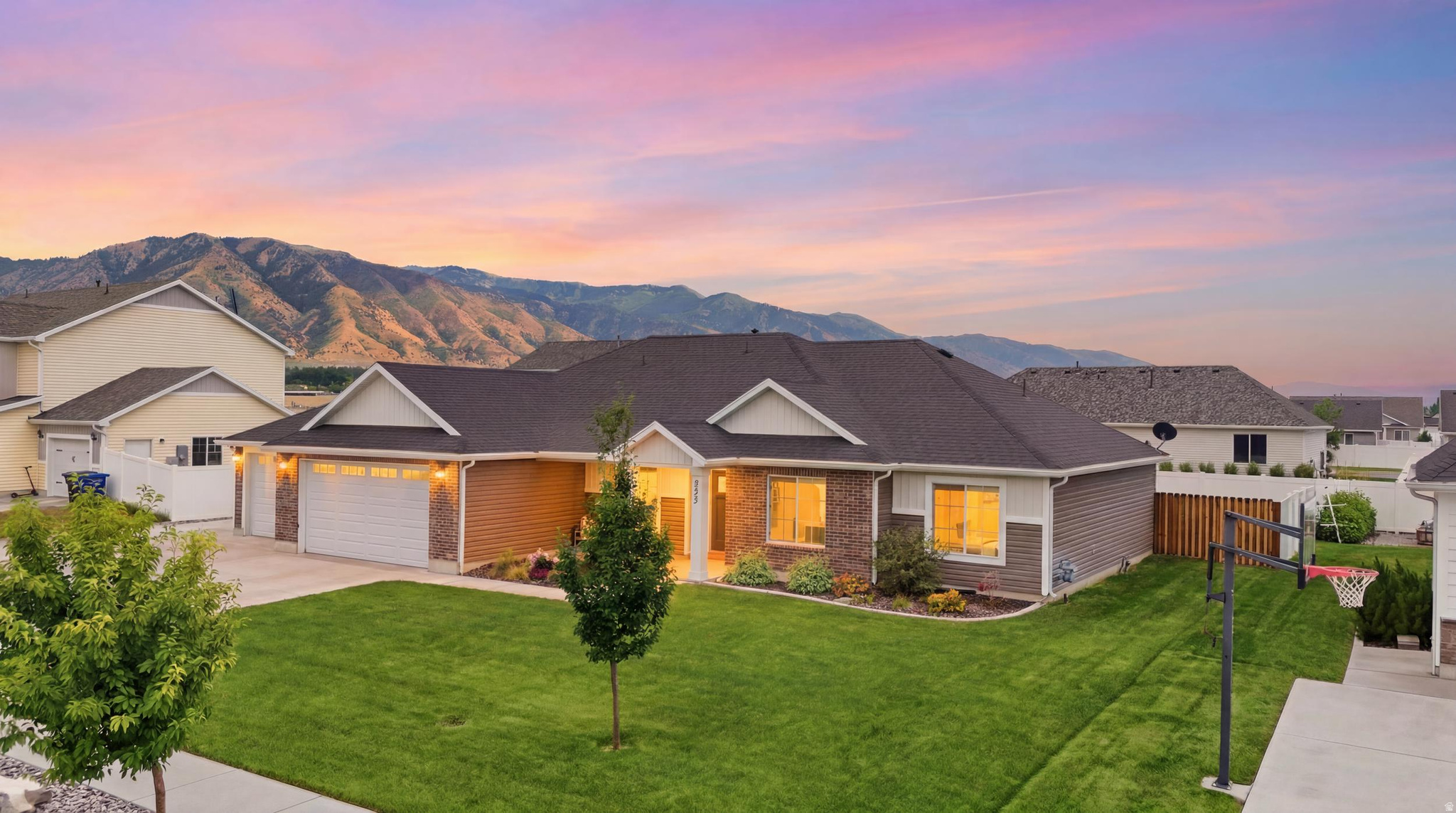 Single level living with elegance, space, and comfort featuring vaulted ceilings, a spacious open-concept family room, dining area, and a gourmet kitchen with ceiling-height dark brown cabinets, a double oven, Bosch dishwasher, and a central island offering plenty of storage and work space. Enjoy mountain views from the fully fenced yard and fully landscaped, complete with a covered patio for outdoor gatherings and an additional spacious RV pad. The 3 car garage has built in shelving and a mini work bench. The yard has three raised garden beds and gates on each side for convenient access and projects. The front room can be a bedroom, office, etc. With the cozy gas fireplace, his home perfectly blends comfort, and modern living. Great location making it easy to get to schools, dining, shopping, etc. Home Warranty included $750. Radon mitigation system installed. Occupied but easy to show. No HOA! Owner/Agent.