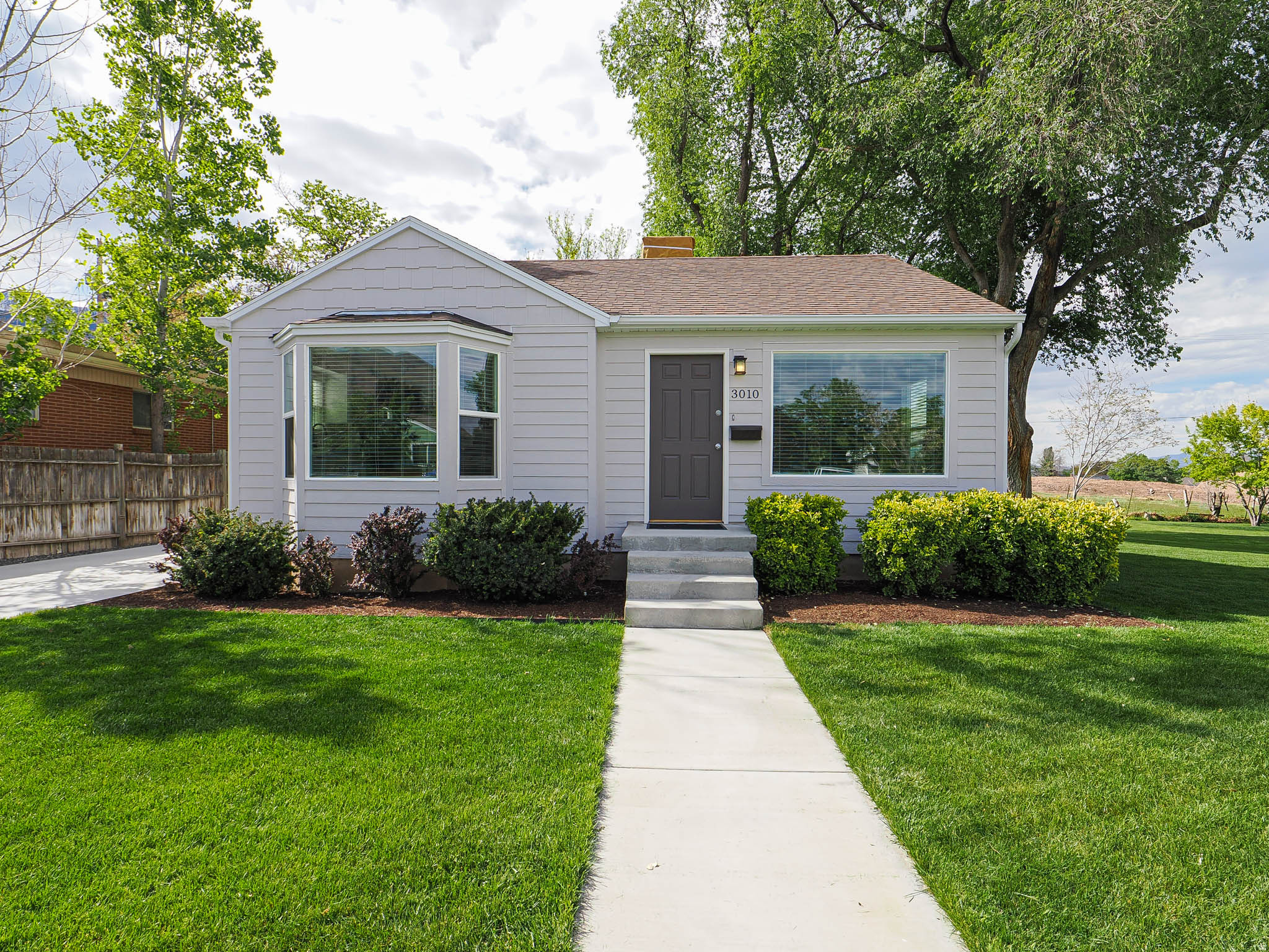 Tucked into the quiet charm of an Upper Millcreek neighborhood, this extensively updated cottage bungalow is really turn key. This 4-bedroom, 2-bath home has been thoughtfully updated and is not a flip! Step inside to find a bright interior with fresh finishes throughout-new flooring, paint, lighting, and fixtures create a clean, inviting atmosphere. The fully renovated kitchen features brand-new appliances, sleek cabinetry, and new countertops, making it both functional and eye-catching. The bathrooms have been tastefully updated with contemporary touches and quality fixtures. Major upgrades bring peace of mind, including a new driveway, copper pipe plumbing (including the main line to the house), new insulated LP wood siding, new furnace, and air-conditioning, ensuring the home feels as solid as it is beautiful. Outside, and sitting on a generous lot, the home offers a large, fully fenced yard-perfect for entertaining, gardening, pets, or simply enjoying the peaceful surroundings. Mature trees and the large backyard add to the sense of comfort, while still being conveniently close to outdoor recreation, trails, and city amenities. Buyer to verify all info including sq ft.