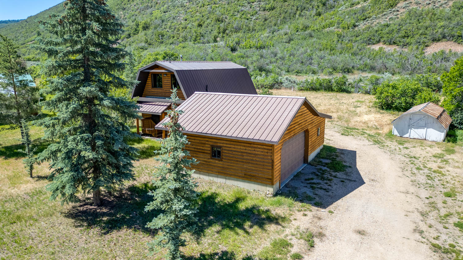 Escape to the peaceful beauty of the Heber Valley with this cozy cabin located a few minutes from shopping, dining, schools and recreation that Heber City has to offer.  Nestled in a quiet location with convenience.  This cabin as a rustic feel, with new flooring, updated bathroom and wood burning stove, making it ideal as a full-time residence or weekend getaway.  The oversized two car garage has an attached workshop providing space for vehicles, recreational toys, projects or storage.  Enjoy country living with services and year round recreation of Wasatch County including world class skiing & fishing, boating, golfing, hiking and more.