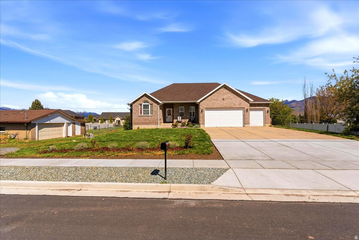 Horse Property! Welcome to this beautifully updated all-brick rambler! The main level features tall ceilings, a dedicated office, and a spacious family room with a cozy gas fireplace. The open kitchen is equipped with KitchenAid stainless steel appliances (all included), and the laundry room offers a sink and cabinetry. You'll find three bedrooms on the main level, including the primary suite with its own fireplace, single vanity, jetted tub, separate shower with cultured marble surrounds, and a walk-in closet. The fully finished walkout basement offers incredible versatility, including potential for an ADU. It has been refreshed with brand-new carpet and LVP flooring and features a large family room with both electric and wood-burning fireplaces, 2 oversized bedrooms, and abundant storage. Car enthusiasts and hobbyists will appreciate the extensive parking options, including an attached 3-car garage with a double-deep bay and a detached 2-car heated garage/workshop. The exterior is equally impressive, situated on a spacious 0.74-acre lot with a new roof (2023) and a large covered deck. The fully fenced backyard is ideal for animals, featuring gated areas, an outbuilding with two stalls, and a hay loft. Square footage per previous listing. Property facts are provided as a courtesy; Buyer to verify all information.