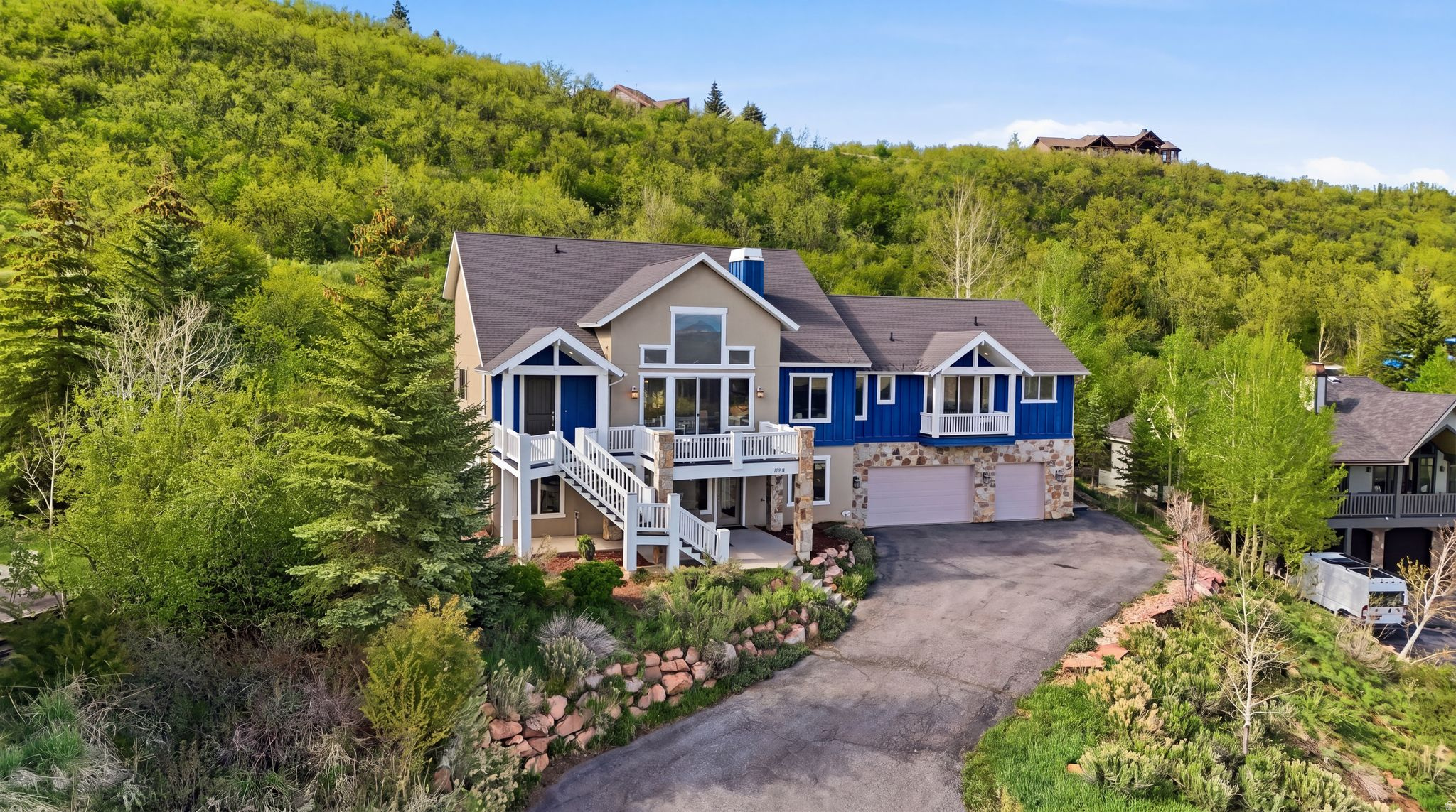 Tucked into one of Jeremy Ranch's most peaceful and private settings, this beautifully remodeled home offers comfort, space, and a seamless connection to the outdoors. Backing to 157 acres of open space, the property enjoys sweeping mountain views from Deer Valley to the Uinta Mountains and beyond, creating a sense of calm and openness that's hard to find. Remodeled in 2018 with timeless, high-end finishes, the home is filled with natural light and designed for easy, everyday living. The kitchen is both functional and inviting, featuring rifted oak cabinetry, professional-grade Thermador appliances, a walk-in pantry, and an oversized stone island with waterfall edges. A cozy banquette provides the perfect spot for morning coffee or casual meals, while access to the private backyard patio and expansive front deck makes indoor-outdoor living effortless. The main living area is warm and welcoming, with vaulted ceilings, a floor-to-ceiling stone fireplace, and large windows that bring in natural light throughout the day. The main-level primary suite offers a true retreat with a spa-like bathroom including heated floors, soaking tub, steam shower, and custom walk-in closet. Two additional main-level rooms with built-ins provide flexible space for offices or bedrooms. Upstairs features two bedrooms connected by a Jack-and-Jill bath with a loft, while the lower level offers a second living area and two additional bedrooms--ideal for guests or multi-generational living. With two patios, a spacious view deck, an oversized laundry room, and a three-car garage, this home blends comfort and functionality. With quick access to both Park City and Salt Lake City, this is a true commuter's dream, while still feeling like a quiet retreat. Surrounded by trails and endless recreation, it's a place where neighbors connect, the outdoors is part of daily life and home feels exactly the way it should - Comfortable, welcoming & easy to enjoy.