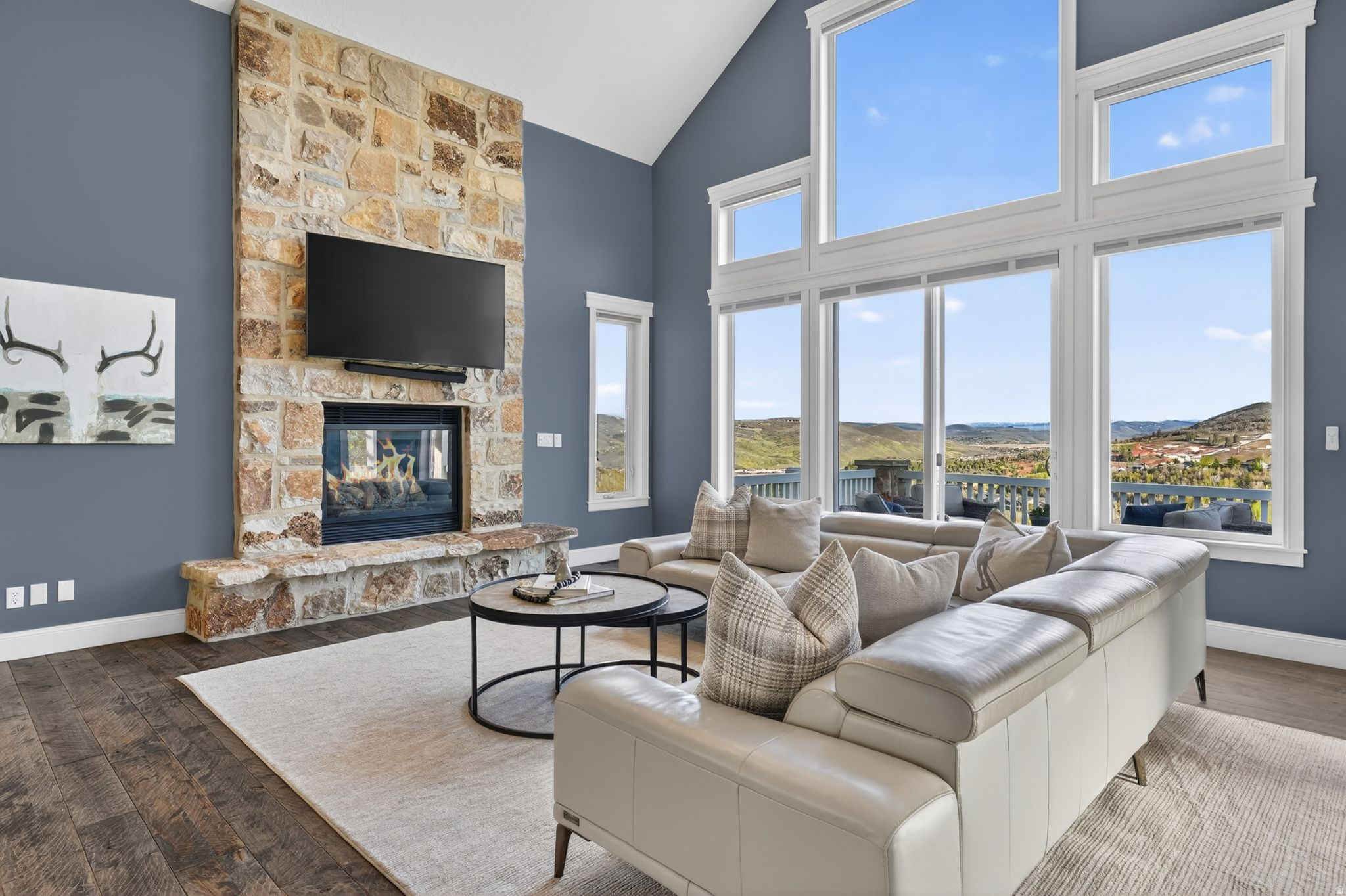 Tucked into one of Jeremy Ranch's most peaceful and private settings, this beautifully remodeled home offers comfort, space, and a seamless connection to the outdoors. Backing to 157 acres of open space, the property enjoys sweeping mountain views from Deer Valley to the Uinta Mountains and beyond, creating a sense of calm and openness that's hard to find. Remodeled in 2018 with timeless, high-end finishes, the home is filled with natural light and designed for easy, everyday living. The kitchen is both functional and inviting, featuring rifted oak cabinetry, professional-grade Thermador appliances, a walk-in pantry, and an oversized stone island with waterfall edges. A cozy banquette provides the perfect spot for morning coffee or casual meals, while access to the private backyard patio and expansive front deck makes indoor-outdoor living effortless. The main living area is warm and welcoming, with vaulted ceilings, a floor-to-ceiling stone fireplace, and large windows that bring in natural light throughout the day. The main-level primary suite offers a true retreat with a spa-like bathroom including heated floors, soaking tub, steam shower, and custom walk-in closet. Two additional main-level rooms with built-ins provide flexible space for offices or bedrooms. Upstairs features two bedrooms connected by a Jack-and-Jill bath with a loft, while the lower level offers a second living area and two additional bedrooms--ideal for guests or multi-generational living. With two patios, a spacious view deck, an oversized laundry room, and a three-car garage, this home blends comfort and functionality. With quick access to both Park City and Salt Lake City, this is a true commuter's dream, while still feeling like a quiet retreat. Surrounded by trails and endless recreation, it's a place where neighbors connect, the outdoors is part of daily life and home feels exactly the way it should - Comfortable, welcoming & easy to enjoy.