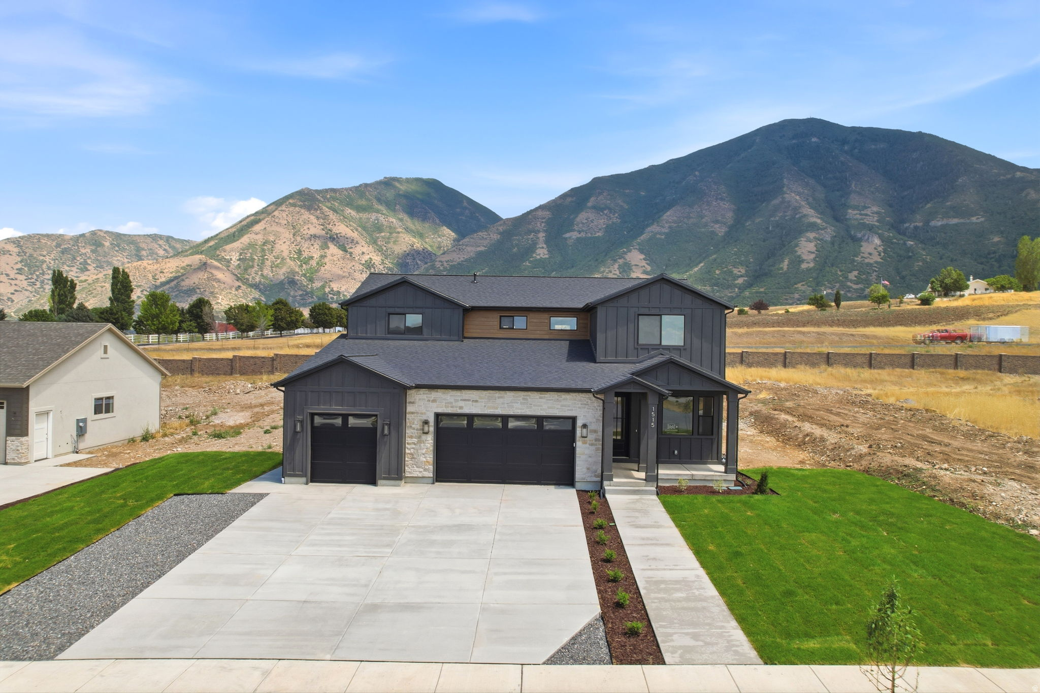 This stunning 2-story new construction just off Woodland Hills Drive offers refined finishes throughout with a thoughtfully designed layout. The home features 4 bedrooms, 3 full bathrooms, and 2 half bathrooms, including a private office on the main level. Enjoy beautiful mountain views, a fully finished expansive basement with space for entertaining, a dedicated gym and a 2 bedroom, 1 bathroom ADU. Front Landscaping is getting done, but the back will be done by whoever buys the home. Get up to $20,000 with a PREFERRED LENDER INCENTIVE to use towards a 2-1 Buy down!