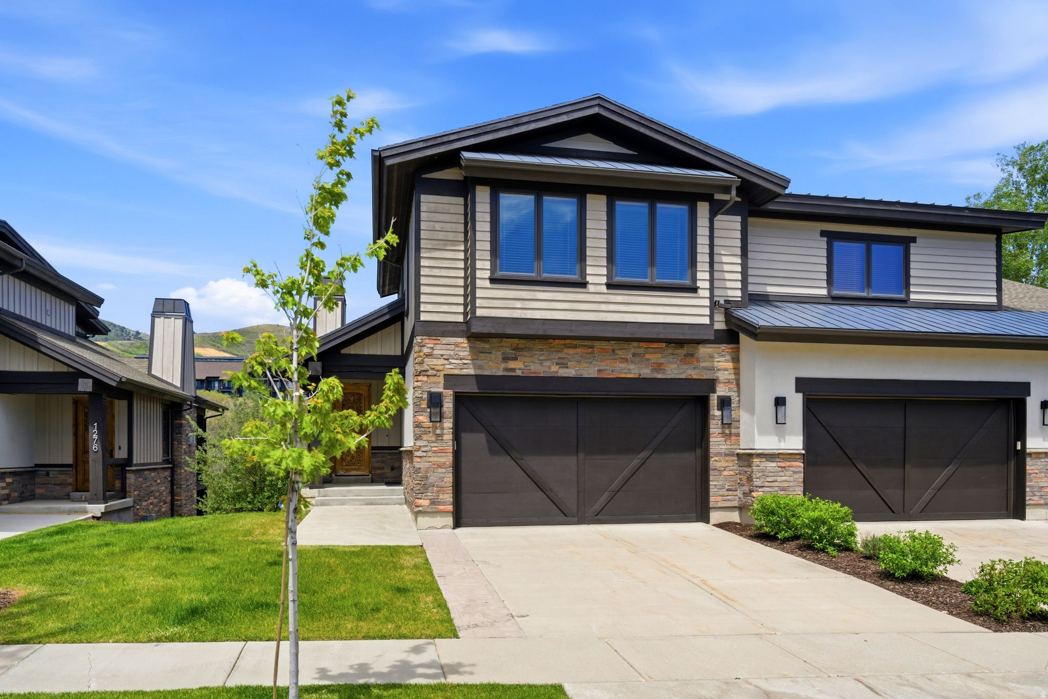 1270 Stillwater Drive is ideally located less than a mile from the new Deer Valley East Village, offering convenient access to world-class skiing and the area's growing collection of amenities. In the opposite direction, Hailstone Marina and the recreational opportunities of the Jordanelle Reservoir are also less than a mile away. This beautifully updated townhome features an inviting floor plan with an open-concept great room, kitchen, and dining area on the main level. Upstairs, you'll find three spacious bedroom suites, including the primary suite. The lower level offers a second family room and a bunk room area, providing excellent flexibility and ample sleeping accommodations for family and guests. Designed for year-round enjoyment, the home includes two covered decks, a private patio, and an outdoor hot tub. Updated finishes and furnishings create a bright, modern mountain aesthetic throughout. The property enjoys scenic views of Deer Valley's ski slopes and the surrounding mountains, while its location adjacent to open space enhances both privacy and the sense of openness. Additional features include a two-car attached garage and generous storage space. Combining an exceptional location, thoughtful layout, and attractive price point, this is an outstanding opportunity to own in one of the region's most exciting and rapidly growing resort destinations.