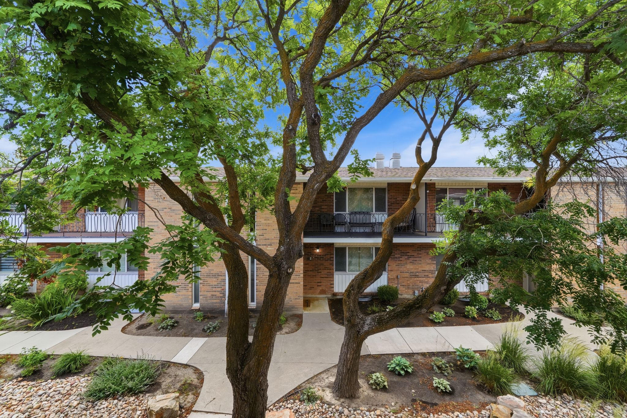 Luxury townhome style condo offering the perfect blend of low maintenance living and spacious, multi-level design. Unlike traditional condos, this beautifully updated residence lives like a private home with multiple levels, a secluded patio/yard area with a built in included exterior TV to enjoy while relaxing in the shade outside, as well as a large walkout deck off the primary suite creating the ideal spaces for relaxing, entertaining, and enjoying the outdoors but getting the benefits of condo living. A 3 car covered carport with storage closets is directly attached to the unit and has private access to your backyard oasis with access to the kitchen only a few steps away as well. Inside, you'll find designer finishes throughout, upgraded lighting fixtures, custom mirrors in the bathrooms, Hunter ceiling fans, accent walls in every room, included oversized wardrobe cabinetry in every bedroom, and custom silhouette window shades that elevate both style and comfort. This property comes fully equipped with all kitchen appliances, TV's, and Washer and Dryer included making this home truly move-in ready! With exceptional amenities,  the HOA covers almost all utilities, snow removal, RV parking, a clubhouse with gathering and hosting space, fitness room, resort style pool, and expansive grassy park areas for kids and pets. Buy with confidence knowing that everything in the unit was replaced in 2018, including electrical systems, HVAC, roofing, patio concrete, all new engineered hardwood flooring, paint, quartz countertops, and water heater offering the benefits of newer construction but with established surroundings and mature community feel. Ideally located near top-rated schools, parks, restaurants, shopping, and grocery stores. Plus their is room for growth as the extra room downstairs could easily be used as a 4th bedroom with double closets/ storage areas. Offering a free 1 year temporary 1% rate buy down when using preferred lender! Schedule your private showing today!