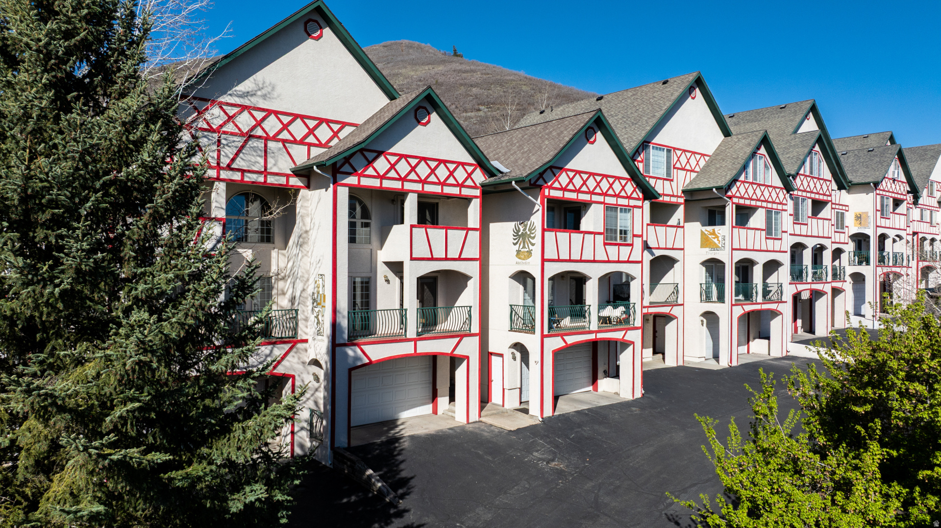 Wake up in the Wasatch foothills. Step out to mountain views and open space. Drive two minutes to Midway. Access Deer Valley skiing via the Jordanelle Gondola in under fifteen. This is the kind of location that sounds too convenient to be true... and then you see it! Tucked into Lime Canyon in the coveted Swiss Oaks community, this light-filled three-story townhome offers one of the more thoughtful floor plans in the valley: three bedrooms and two bathrooms on the second level, plus an oversized flex room on the third that functions equally well as a fourth bedroom, office, or bunk room depending on who's moving in. The east-facing orientation frames morning views of the Heber Valley; the open space behind the property means no rear neighbors... just wildlife and ridgeline. The three-car garage with dedicated storage and utility room is the kind of thing buyers don't realize they need until they have one. Skis, bikes, paddleboards, UTVs-there's room for the full Utah lifestyle. Inside: washer/dryer included, water softener, Ecobee Smart thermostat, LED fixtures throughout, and laminate flooring in the living room and both upstairs bathrooms. The primary bedroom opens to a private balcony with a roller shade. Swiss Oaks HOA is well-equipped with fiber optic internet, gym, sauna, tennis, pickleball, basketball, clubhouse, hiking trails, and a kids' play area. Zermatt and Homestead Resorts, Wasatch State Park, Jordanelle Reservoir, and Soldier Hollow Nordic Center are all within minutes. Visit SwissOaks.com for community details. 30-day minimum rental.