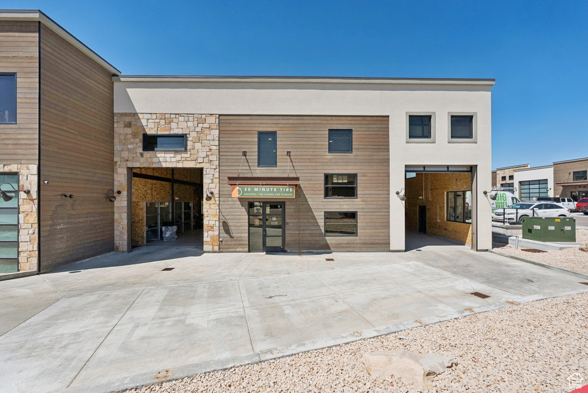 Park East II's largest unit, G42, encompasses the space of five typical commercial condominium units within the project, and it includes the accompanying parking- 10 exterior spaces. Main-level office tenant improvements are being constructed now in one 'bay' with a second-floor storage mezzanine above and into an adjacent bay. Two 14' overhead garage doors provide interior vehicular access, and ceiling heights allow for everything from tall industrial racking applications to modest climbing walls. The ground floor area is approx. 9,000 SF; the plat also entitles the owner to add up to 9,000 SF of additional second-story space, for a total of 18,000 SF of interior space. This building also features multiple doors for myriad egress points and internal/external circulation patterns around the exterior commercial loading dock. This location is conveniently located between two highway exits from Hwy 40- mere minutes from Main Street Park City- and just down the road from the I-80 interchange to Salt Lake City. Summit County's Service Commercial zoning district allows for unbelievable flexibility for an end user of this space. Whether it's unleashing the full potential of a growing business or crafting the ultimate 'bat cave,' this space is dying to be maximized.