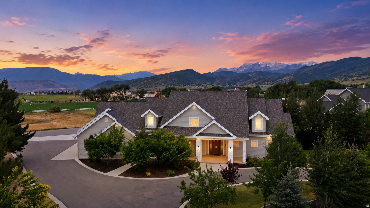 Set on a fully landscaped acre with open views of Mount Timpanogos and the Wasatch Range, this 5,100-square-foot modern farmhouse was built in 2016 and combines three things rarely found together in the Heber Valley: newer construction, main-level living, and 15-minute access to Deer Valley skiing.  The floor plan is built around a grand great room with vaulted ceilings and oversized windows that fill the main level with natural light and frame the mountains from nearly every room. The primary suite is on the main floor. Three additional bedrooms, a dedicated office, two fireplaces, and a second kitchen give the home the flexibility to comfortably host family and guests.  The home is as practical as it is polished. A four-car garage holds vehicles and gear for every season, and geothermal heating and cooling keep a home of this size comfortable and efficient year-round. Outside, a covered patio overlooks landscaped, fully irrigated grounds with room to play, garden, and entertain, without the upkeep that larger parcels demand.  The location puts the best of the Wasatch Back within easy reach. The newly expanded Deer Valley East Village is roughly 15 minutes away; the Heber Valley Airport is minutes from the driveway for private aviation; and Salt Lake City International is under an hour away. Midway's shops and restaurants, golf at Homestead and Soldier Hollow, fly fishing on the Provo River, and the trails of Wasatch Mountain State Park are all close at hand.  For the buyer seeking a newer, light-filled home with space, privacy, and immediate access to skiing, golf, and year-round recreation, this combination is increasingly difficult to find in Midway.