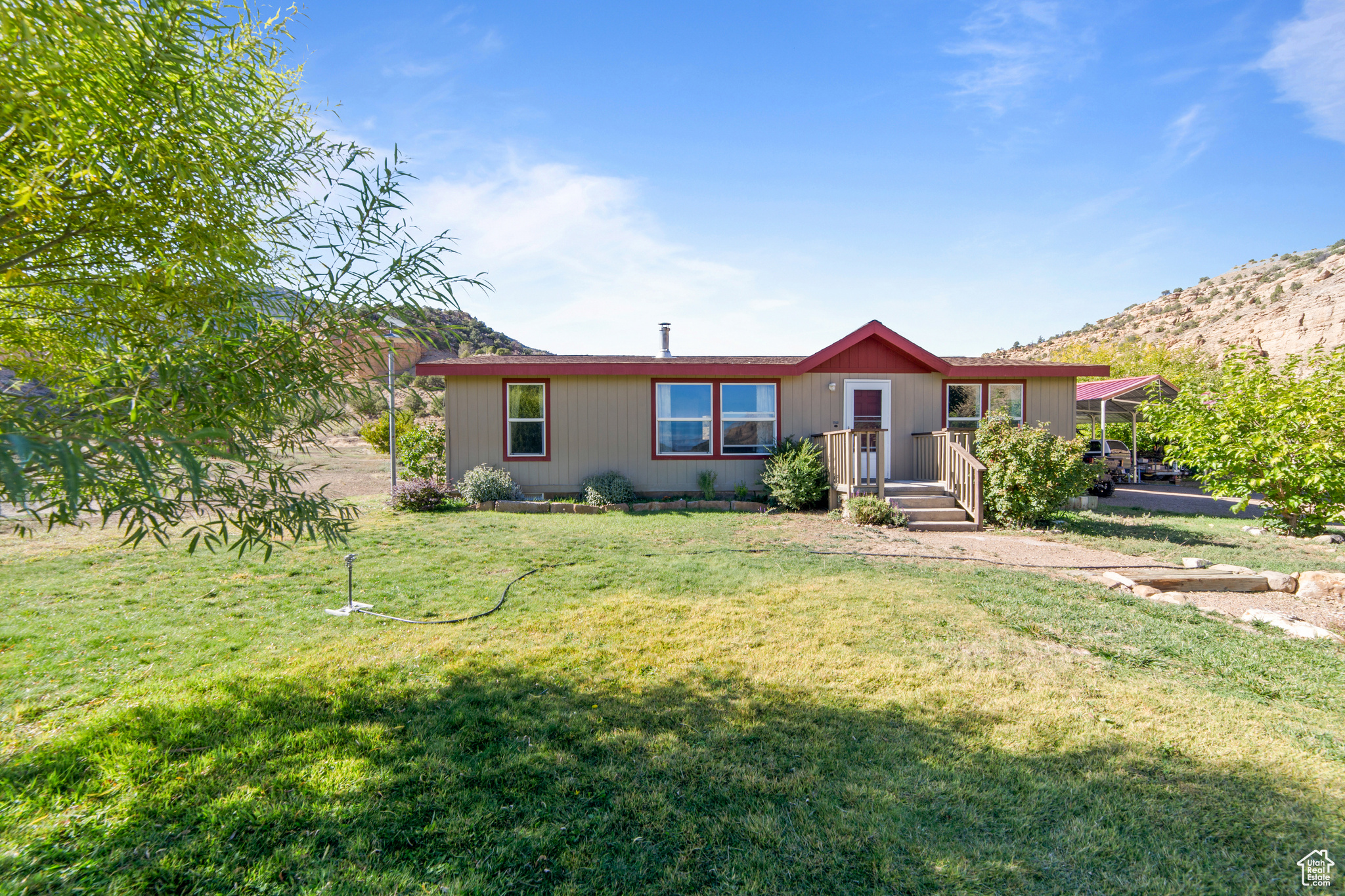 Look no further to realize your Country Living Dream! 70 scenic acres available in Thompson Canyon, providing a rare opportunity to live self-sufficiently in a high desert haven. Built in 2016, this 1,179 sq. ft. manufactured home has three bedrooms, two baths, and a permanent concrete foundation. Designed for energy efficiency with an Energy Star wrap, solar and hydroelectric systems, and Starlink internet for remote work and schooling. Grow fresh produce right outside your door with senior spring-fed water rights for domestic, irrigation, and stock use that provide reliable water to six 4'x16' raised garden beds, peach trees, and a small orchard. A root cellar keeps harvests cool and preserved, while two 24'x24' steel carports, a tool shed, and solar house add practical support for off-grid living. Sitting just beyond the renowned Sego Canyon rock art sites, this property is surrounded by open land and native wildlife: deer, pronghorn, bighorn sheep, chipmunks, hummingbirds, and more. Clear night skies reveal the Milky Way in brilliant detail. When you decide to venture off this remote paradise, there is access to Moab (42 mi), Green River (31 mi), and Grand Junction (80 mi). Nearby national treasures include, but aren't limited to, Arches, Canyonlands, the Colorado River, and Dead Horse Point. Whether seeking sustainable living, a creative retreat, a quiet setting ideal for home-based activities, or a private base to explore Utah's canyon country, this property is built to ensure comfort, independence, and natural beauty. Sale includes Tax ID 04-0020-0071 and 04-0020-72. Adjacent 20 acres available, see MLS #2062239.