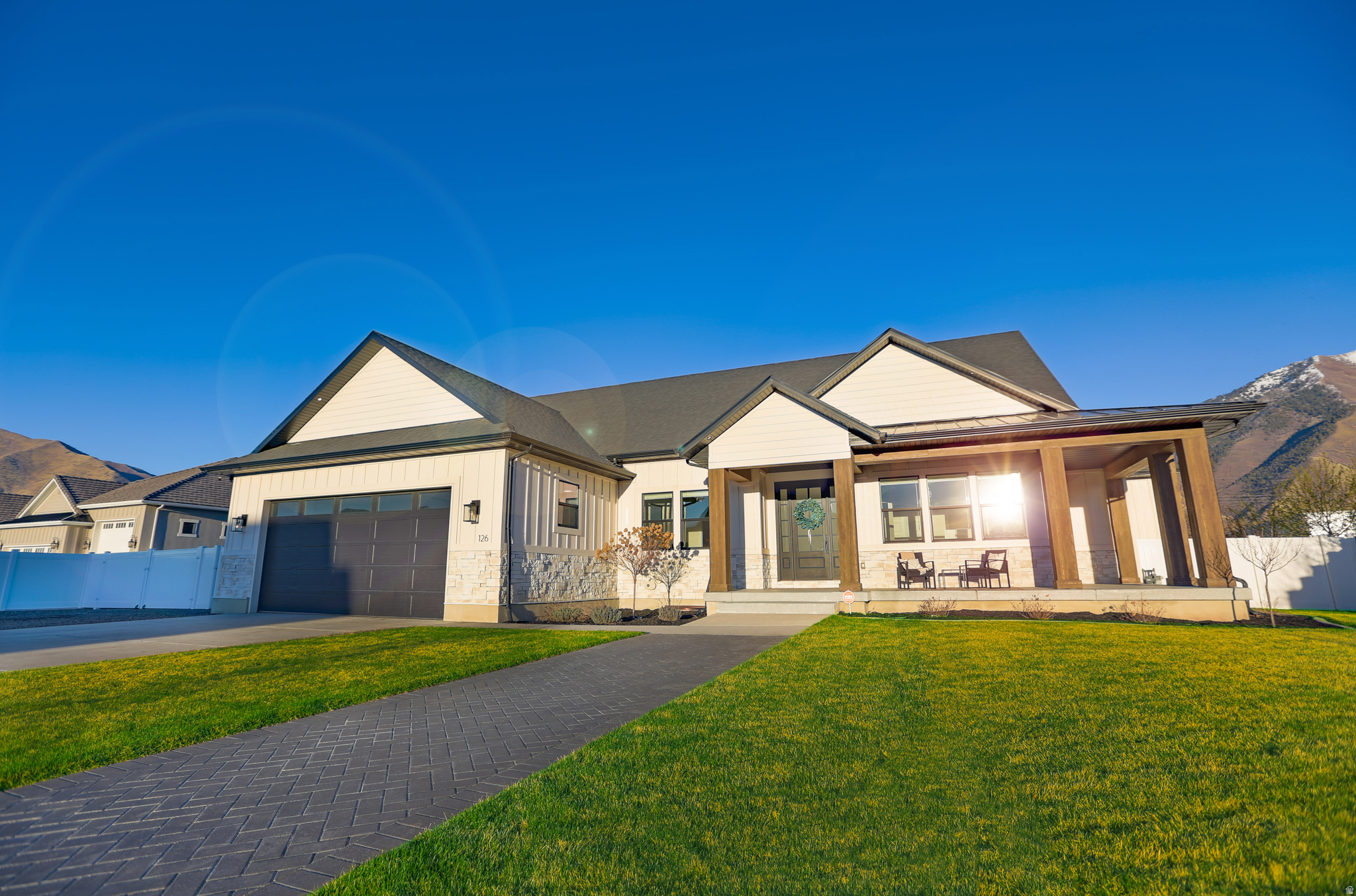 The pinnacle of craftsmanship, this custom palatial rambler offers striking finishes on .83 acre of horse property, with a wraparound covered corner porch. Experience unrivaled luxury where no expense was spared, set on a quiet street with unobstructed views of Maple Mountain and no back neighbors--ever. Inside, over $150,000 in custom solid oak, walnut, and painted cabinetry anchors the home, complemented by a main floor double island and shiplapped tray ceilings with custom beams. Designed for multi-generational living, the home features two full kitchens with black stainless steel appliances and oversized stunning quartz  counters. The structural upgrades are equally impressive: blown-in high-density cellulose in the joists, the thickest luxury LVP flooring on the market, and a full basement with its own zoned HVAC and soundproofing. A fifth flex den/bedroom off the entry foyer. The extra-deep/wide garage easily accommodates two long-bed trucks with room to spare with extra height, depth, and width--and with plenty of room for a three or 4 car addition. Outside, enjoy $35,000 in epoxy patios and over 2,000 sq. ft. of covered entertainment space, complete with hot/cold exterior spigots, a hot tub hookup, and pressurized irrigation. This is Mapleton living without compromise. Make it yours today!