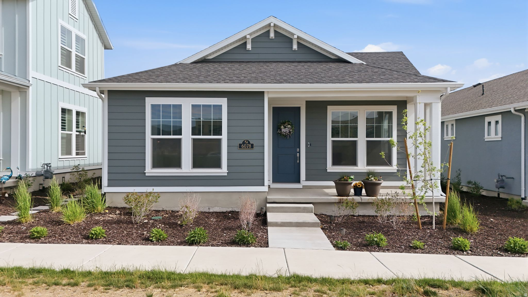 Experience peaceful, low-maintenance living in the highly sought-after SpringHouse 55+ community in Daybreak. Designed for those seeking a quieter lifestyle with exceptional amenities, this beautifully maintained 1-year-old home offers 2 bedrooms, 2 bathrooms, and the perfect blend of comfort and convenience.  Why wait to build when you can purchase for less and enjoy a move-in-ready home with upgrades already completed? This home includes a fully landscaped private backyard, window blinds, and a modern induction stovetop-saving you time, money, and the hassle of new construction.  Enjoy quiet mornings and relaxing evenings in your private outdoor space while taking advantage of SpringHouse's incredible resort-style amenities, fitness spaces, pools, walking trails, clubs, and social activities within the vibrant Daybreak community. Easy living, modern finishes, and an unbeatable lifestyle all come together in this exceptional active adult home.