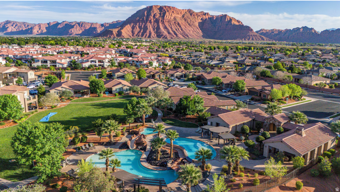 Enjoy luxury living in this fully furnished NIGHTLY RENTAL with stunning views of Red Rock and Snow Canyon. Located in the quiet outskirts of Santa Clara at Paradise Village Resort, this refined home is just minutes from St. George while offering peace and privacy. The residence features wheelchair accessibility, a private hot tub, gas grill, and curated entertainment spaces. The gourmet kitchen is beautifully appointed with stainless steel appliances, granite countertops, and a spacious center island. Comfortably accommodating up to 14 guests, the home is ideal for elevated gatherings and relaxing escapes. Resort amenities include a fitness center, resort-style pool, and a 20-person hot tub directly across the street, along with a stunning two-tiered family pool, splash pad, and lazy river designed for effortless leisure.