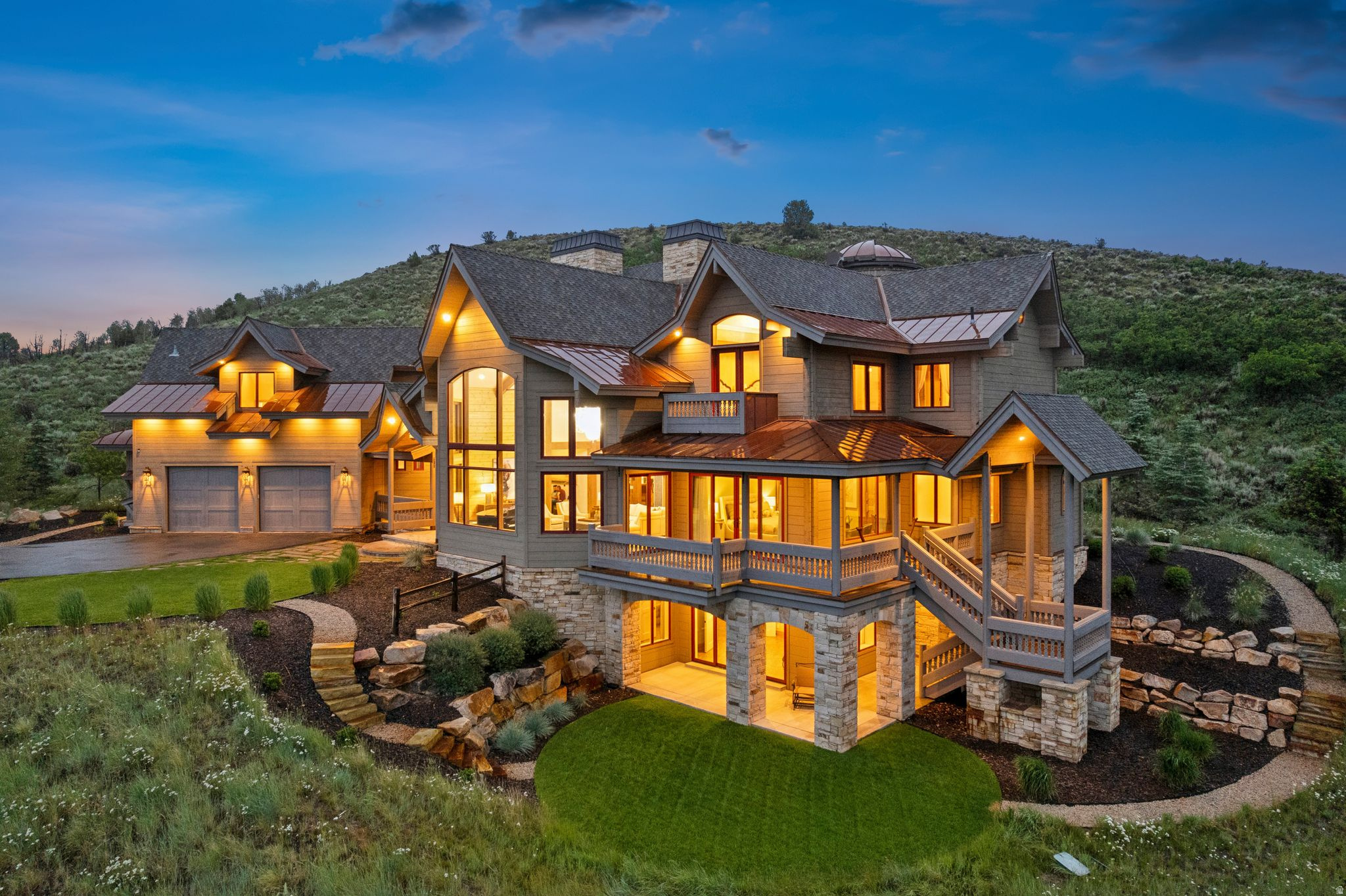 Behind the gates of Victory Ranch, Park City's premier private golf and fly-fishing community, sits a home that was built to be lived in, completely, by the people who imagined every inch of it. Set on more than four private acres above the Rees Jones-designed golf course, the residence was conceived and constructed by its owners as a single, continuous idea about how a life should feel. The timber was milled in Finland and raised by hand on site, solid and natural and free of synthetic insulation. The walnut underfoot, the curved walnut and maple doors, the hand-set stone, the custom lighting: each was chosen, and each carries meaning. That sense of intention is what you notice first. Beneath soaring vaulted ceilings, a four-sided fireplace anchors the great room. The kitchen gathers around a walnut countertop with a luminous blue inlay, custom walnut, maple, and glass cabinetry, and a wood-fired Pechka and pizza oven built on site by a master mason. A round dining nook, wrapped in windows, holds the morning light. The stone turret is the home's quiet astonishment: a curved walnut library with inlaid floors beneath a private observatory crowned by a retractable dome and a commercial-grade telescope, an invitation to the night sky that almost no private home can make. Nearby, a thousand-square-foot Banya spa holds a swim spa, sauna, and steam room beside a glass conservatory. Across roughly nine thousand square feet, five en-suite bedrooms include two primary suites, one on each level, each framing its own long view. The lower level holds a family room, a fitness studio, and a private office with its own entrance and patio. Outside: covered dining, a built-in grill, balconies that follow the sun, a two-car garage, and a custom dog wash. Ownership at Victory Ranch is what completes the picture. Beyond the gates lie more than 6,250 private acres, four miles of the Upper Provo River reserved for residents, and some of the finest fly fishing in the West. Members enjoy the Rees Jones golf course, a clubhouse with pool, spa, and fitness, riverside dining, a five-stand shooting range, paddle tennis, more than thirty miles of trail, and a private ski-in, ski-out lodge at Park City's Town Lift. Deer Valley and Main Street are fifteen minutes by car; Salt Lake International is about an hour away. It took years and an unrepeatable set of hands to build. There is no second version of this house.