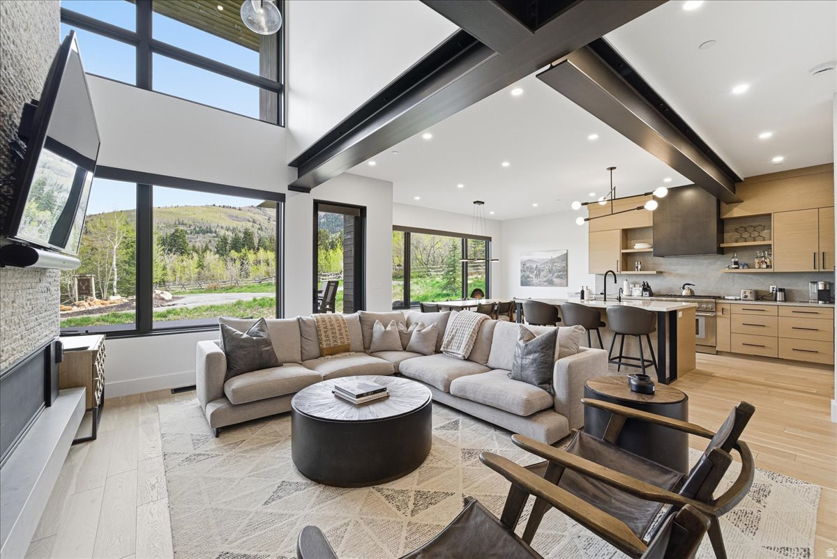 This well-maintained Canyons Village townhome offers the rare combination of ski-in access, walkable proximity to the new lift, and a turn-key interior that feels like new.       Designed for easy ownership and resort use, the home works well as a personal mountain residence, vacation property, or nightly rental. The downhill floor plan creates a clear separation among the main living area, private bedroom suites, and the lower-level gathering space.       The main level is bright and open, with vaulted ceilings, large windows, and views toward Iron Mountain. The great room opens to a private deck with a hot tub, creating a comfortable place to unwind after skiing, biking, hiking, or golf. The kitchen and dining areas are designed for hosting, with quality finishes and a clean mountain-modern feel.       Upstairs, three-bedroom suites offer privacy, comfort, and generous closet space. A landing office nook adds a practical workspace with mountain views. The lower level expands the home's flexibility by adding a second family room for movies, games, or additional gathering space, along with an oversized bunk room that serves as the fourth suite.       The home has been maintained as new and improved with designer-selected furnishings, a home management system, automatic blinds, built-in closet storage, and other behind-the-scenes upgrades that make ownership easier. A two-car garage and large mudroom provide the storage needed for skis, bikes, golf gear, and year-round Park City equipment.       Located in Canyons Village at Park City Mountain Resort, the property is close to skiing, golf, biking trails, restaurants, shops, and resort amenities. The home offers ski-in convenience, shuttle service, and walkable access to the new lift, with Park City's historic Main Street approximately 10 minutes away.       Contact your agent for details about this Canyons Village ski property.