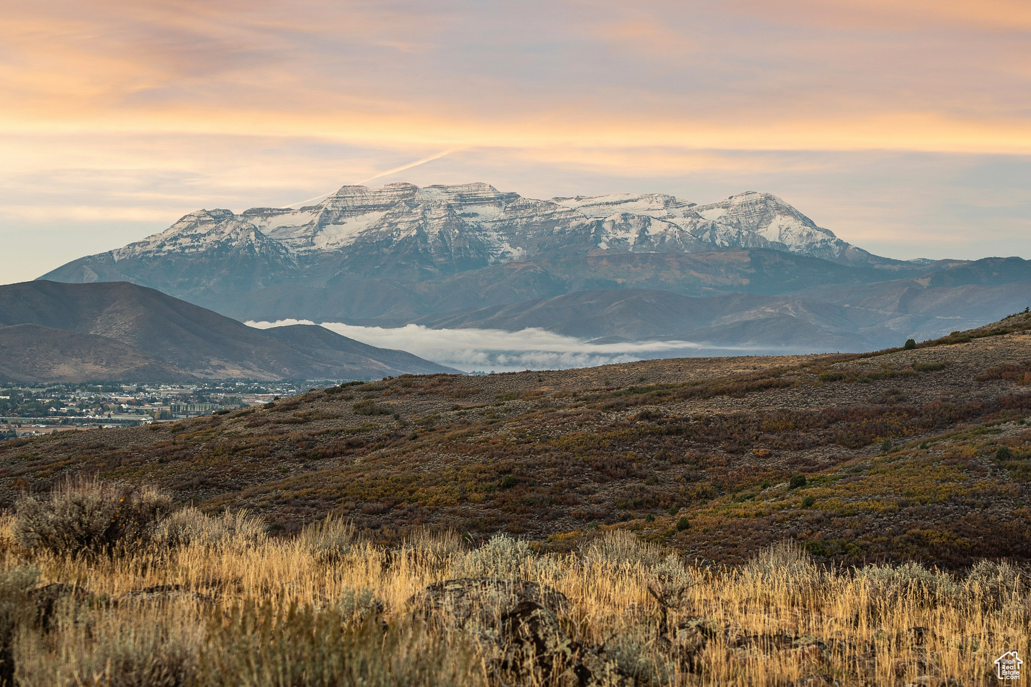 Commanding, unobstructed views of Mt. Timpanogos, Heber Valley, and Deer Creek Reservoir define this extraordinary 163-acre estate parcel inside the Heber Gate of Wolf Creek Ranch - offering the perfect blend of privacy, access, and mountain beauty. Just minutes from Heber City and only 30 minutes to world-class skiing at Deer Valley's new East Village, this property combines seclusion with unmatched convenience.  A gently sloped, build-ready homesite surrounded by rolling sage meadows provides the ideal setting for your future retreat. Fully approved architectural plans from THINK Architecture are included, saving time and streamlining your build. Utilities (fiber internet, power, and water) are at the road, with no build timeline required.  Enjoy 60 miles of private trails, stocked fishing ponds, equestrian facilities, and the Ranch Center with gathering spaces and a guest house for owners. With its rare combination of Timpanogos views, Heber Gate access, and proximity to world-class recreation, this property embodies the finest of the Wolf Creek Ranch lifestyle - private, timeless, and ready to build.