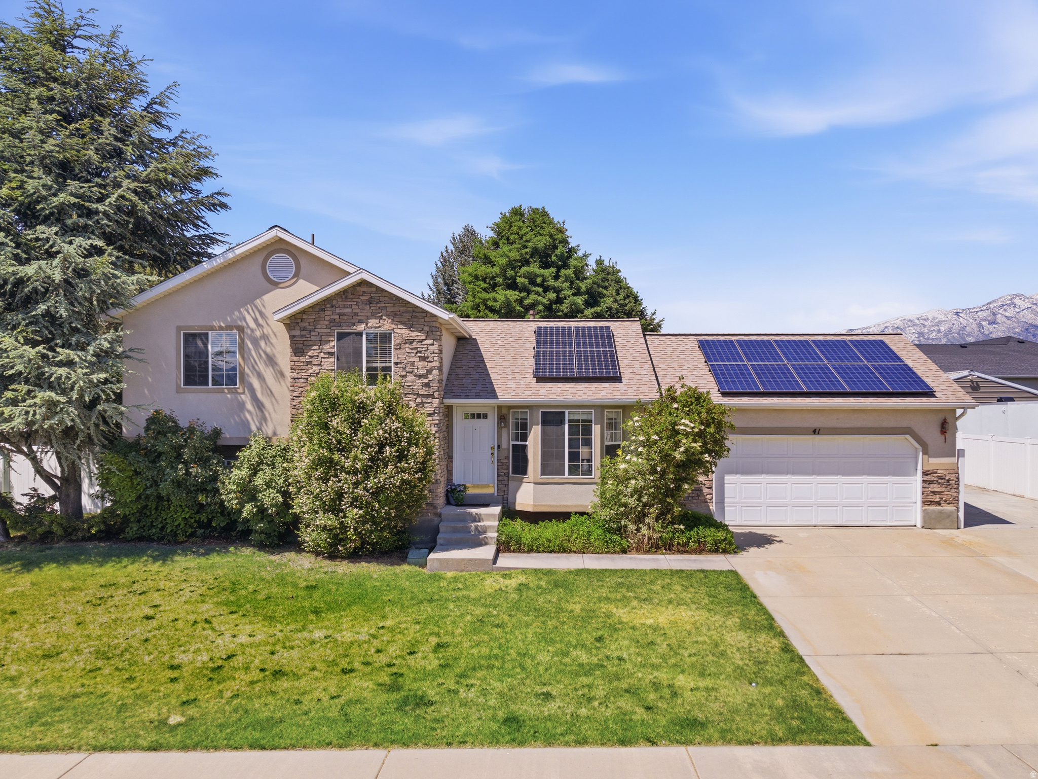 Charming split-level home in a highly desirable Lehi neighborhood just two blocks south of Skyridge High School! This 3-bedroom, 2-bath home features brand-new carpet and fresh paint throughout, creating a clean and move-in-ready feel. Enjoy multiple living spaces including living room, kitchen and a cozy family room with fireplace. Spacious laundry area in an unfinished basement which allows room to grow. Two bedrooms in basement have been drywalled and ready to finish, making this home potentially a 5-bedroom home. Solar fully paid for. Situated on a .29-acre lot with mature trees, fenced yard, and French doors leading to the backyard, this property offers both privacy and outdoor enjoyment. Take in beautiful mountain and lake views from this well-located home close to schools, parks, shopping, and commuter access. A fantastic opportunity in the heart of Lehi!