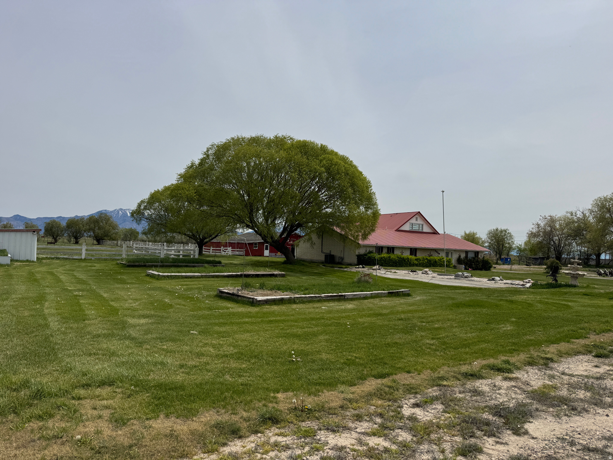 Welcome to the dream life... This is a rare opportunity to own a Weber County homestead with 3.01 acres of land (two parcel numbers) a 3,536 sq ft home, huge barn/garage with horse stalls, garden, beautiful yard, your own pond, and - the cherry on top - a hot tub to relax in after a day on your farm. Home features 6 big bedrooms, 2 huge living rooms, 2 bathrooms, roomy kitchen, formal dining, sunroom, wood stove, and so much storage, you'll never run out of space. (See the virtual videos) Paid off solar panels. Outside you'll have plenty of open space, corrals, pastures and pens for all the animals you could ever want to raise. A sprinkling system keeps the lawn and garden green and one owned water share is included. Numerous outbuildings include a huge barn with space for cars, trucks, tractors and toys, and 5 horse stalls with concrete floors and custom sliding doors.   Acreage, parcel configuration, and property details are provided as a courtesy estimate only. Buyer and buyer's agent to verify all information.