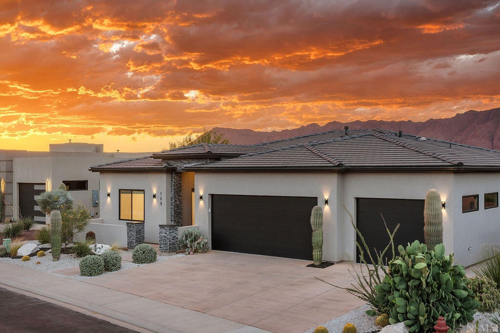 Welcome to this modern luxury immaculate single-level home! This 3 bed 3.5 bath 2,552 sqft home offers a spacious layout with a perfect blend of high-end contemporary design with panoramic unobstructed views of Red Mountain. Also features a hard to find ADU studio-ideal for guests, office or a rental! Single-level seamless, zero-step living throughout the entire property inside and out. Chef's kitchen is equipped with a massive central island, premier appliances including a built-in range with a sleek hood and cutting-edge, fingerprint-resistant cabinets. Enjoy the open pantry with plenty of shelving and storage. Set back and relax in the comfort of your own home while looking through the large picture windows in the living room, dinning area and primary bedroom that showcase the amazing rare views of Red Mountain. Or relax outside and enjoy the quiet surroundings, amazing sunsets, and views under your covered patio with your private fire feature. Pristine professionally designed desert landscaping offers striking cub appeal with effortless upkeep.