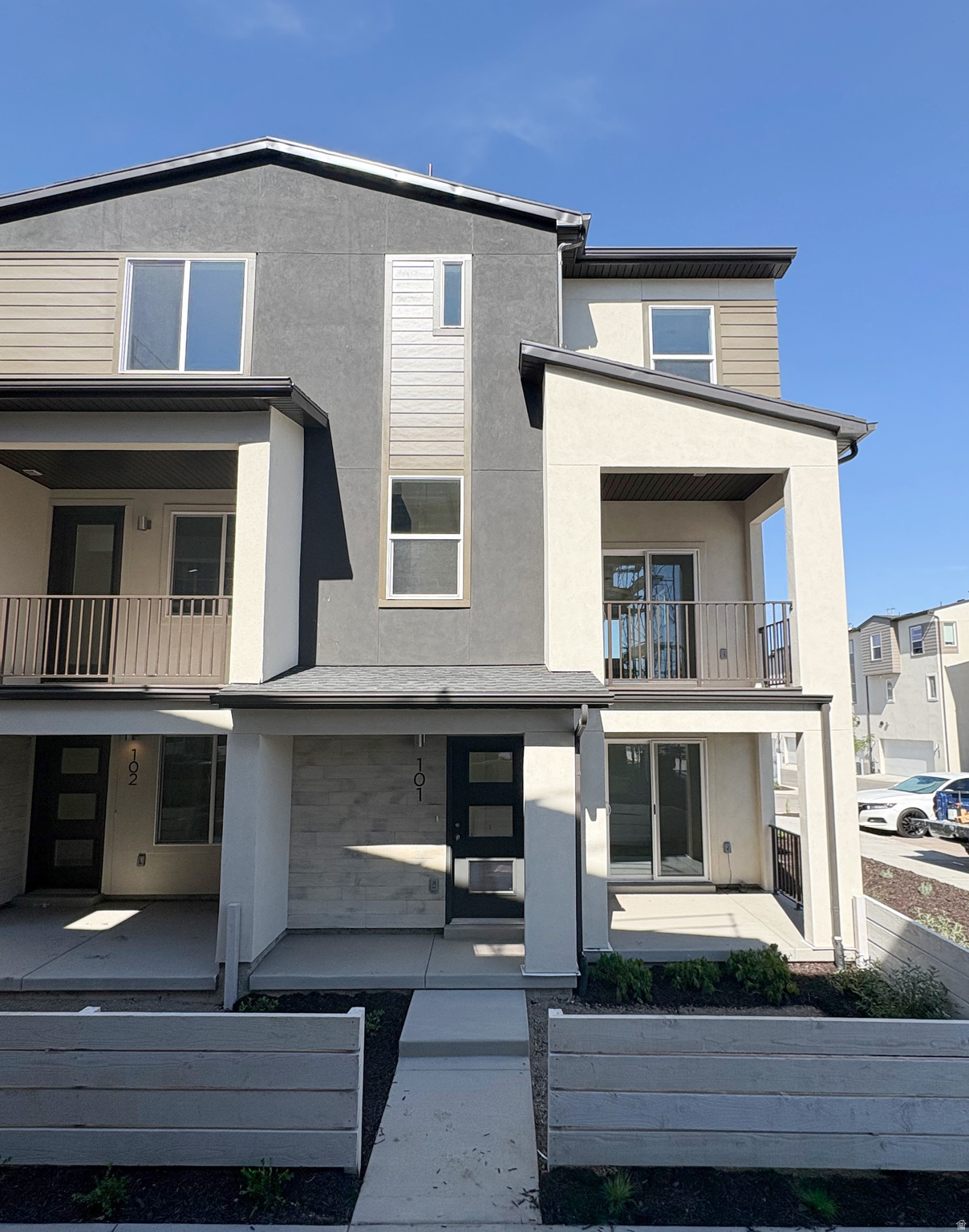 Picture yourself living in one of Murray's most connected and convenient communities. Walk or bike along the nearby Jordan River Trail, grab dinner or shop just minutes from home, and enjoy quick access to I-15, I-215, downtown Salt Lake City, the airport, hiking, skiing, and everything Utah has to offer.  This bright end-unit townhome is filled with natural light from windows on three sides and offers a fenced front yard, oversized patio, private balcony, and subtle mountain views-creating the perfect spaces to relax, entertain, or unwind after a busy day. Inside, the open-concept layout features a spacious kitchen with stylish dark gray cabinetry and inviting living spaces designed for everyday life.  Built with Garbett Homes' signature high-efficiency standards, you'll enjoy enhanced insulation, energy-efficient windows, instant hot water, a programmable thermostat, solar-ready wiring, and a private garage with an EV outlet-providing year-round comfort and lower utility costs. The community also features green space, a playground, BBQ gathering area, and ample guest parking.  With up to $15,000 in savings, one of the best values in the neighborhood, and a location that makes every day a little easier, this is your opportunity to enjoy low-maintenance living without sacrificing convenience or style. Visit our model home today!