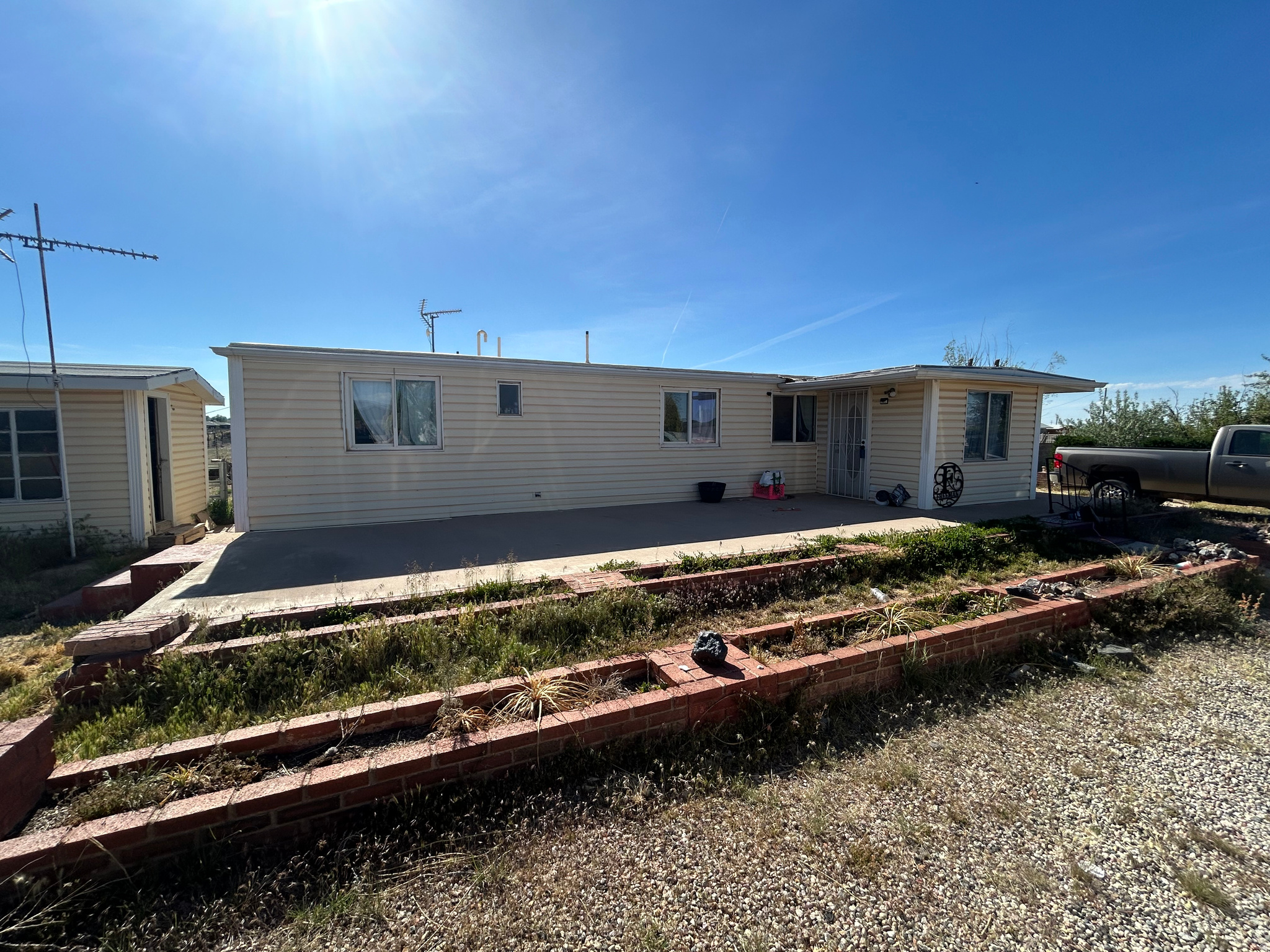 Limited Time on Market! This recently renovated manufactured home gives you a great location, with the opportunity to develop the land.   It is on a 2.27-acre fully fenced lot, which is zoned R2, giving the opportunity for future investments, along with the opportunity for livestock and homesteading-type hobbies. This property also includes a shed that has electricity. The roof was replaced in 2020, and the appliances that were replaced last year are negotiable. This home is on a shared well, which is $150 a quarter or $600 a year.