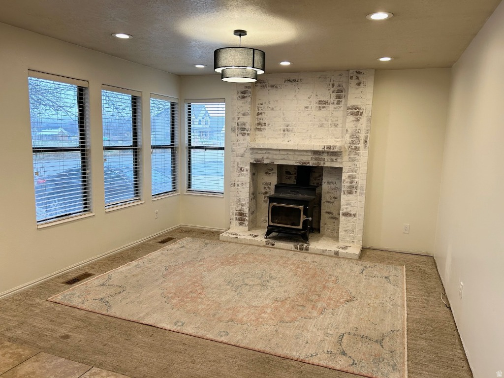 This beautiful home is located in a quite neighborhood. It features a cozy living area and a large bonus room that could be converted to a garage, if desired. Both rooms include functional wood-burning stoves. The basement includes a new kitchen and washer/dryer hook-ups. With a separate entrance in the back, it is perfect for rental opportunities. The roof was completely redone about 6 years ago.