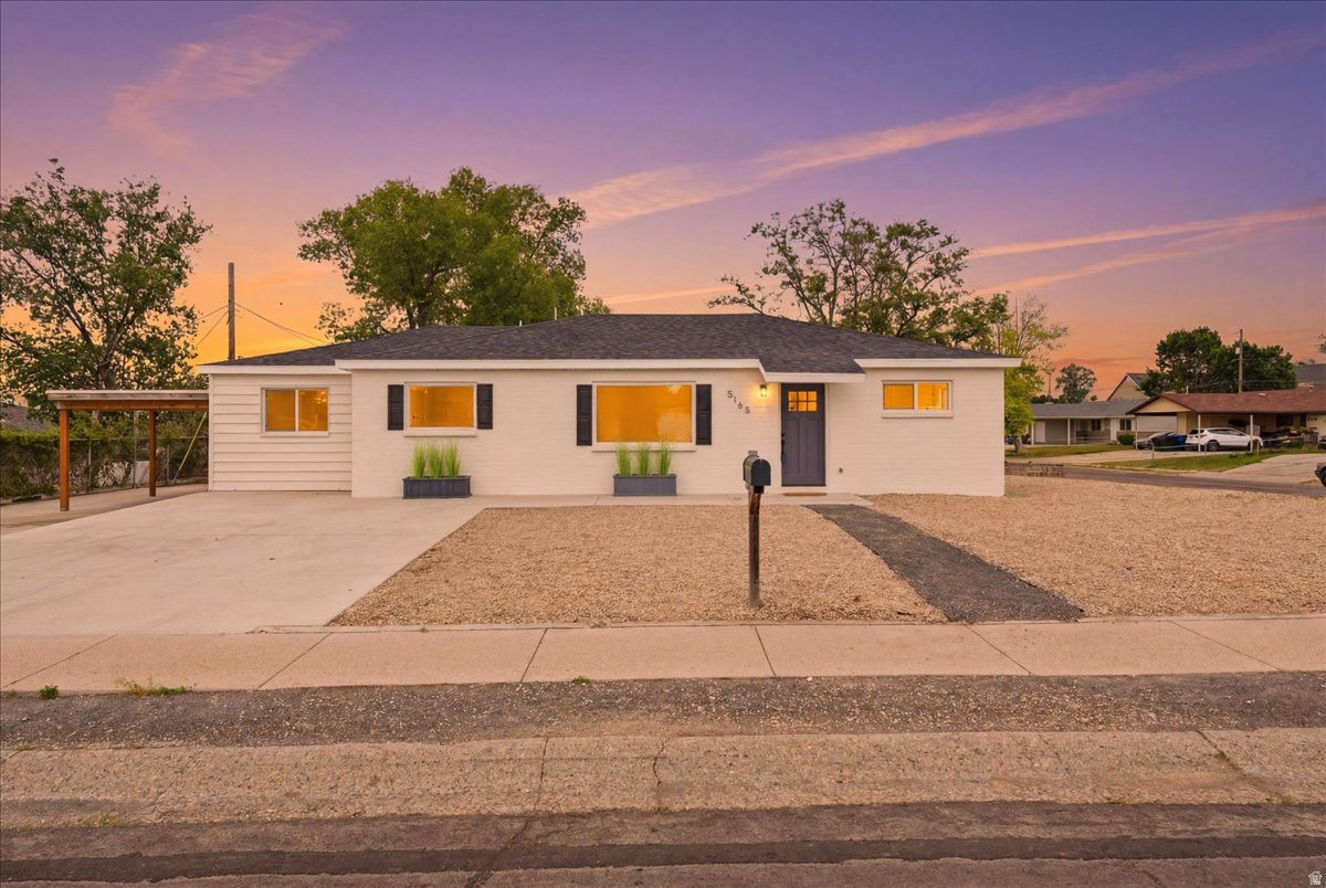 ** Back on the market..Buyers financing fell through** Single-level living with clean modern updates and standout curb appeal. Fresh interior and exterior paint give the home a bright, refreshed feel, complemented by minimalist landscaping and a crisp contemporary look. Inside, you'll find upgraded cabinets, granite countertops, and a newer furnace for added comfort and efficiency. The covered carport includes an electric vehicle charger, while the xeriscaped yard offers low-maintenance living with garden boxes and mature fruit trees for added character and functionality. Conveniently located in the middle of the valley, this home is close to shopping, schools, restaurants, and public transit. Enjoy nearby amenities including the Olympic Oval featuring ice skating, speed skating, and an indoor running track, plus parks, a swimming pool, recreation center, and library all just minutes away. Check out the virtual tour.