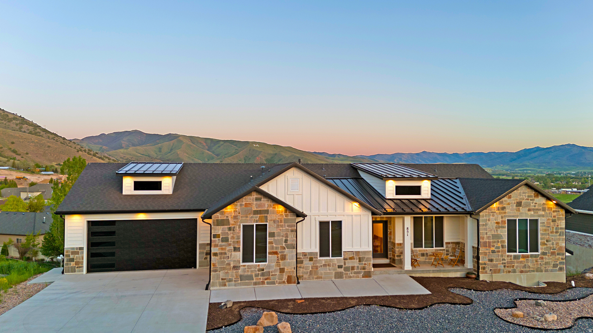 --- 4.6% Loan available with Lender Credits 2/1 buydown. Contact Pete Thomson for info. ----      Perched perfectly to capture breathtaking mountain and valley views, this barely lived-in custom home offers a rare combination of luxury, privacy, and modern design. From the moment you arrive, the stunning curb appeal, elevated setting, and unobstructed scenery set this home apart. Inside, soaring ceilings throughout (9' on the main level and 10' in the basement) create an open, light-filled feel that perfectly complements the expansive views from nearly every angle. The beautifully designed kitchen features waterfall countertops, custom cabinetry, a large walk-in pantry, designer lighting, and high-end finishes throughout. The spacious primary suite was designed to feel like a private retreat with a spa-inspired bathroom featuring a freestanding soaking tub, oversized walk-in shower, dual vanities, and elevated modern finishes. The fully finished basement provides incredible flexibility with space for a home gym, theater room, game room, craft room, or additional entertaining area. The oversized 3-car garage offers ample room for vehicles, storage, and toys. Step outside and enjoy unmatched privacy with no homes directly behind you and panoramic mountain and valley views that are almost impossible to find. Whether you're relaxing on the covered deck, entertaining guests, or simply enjoying the peace and quiet, this home was designed to maximize both comfort and scenery. This is luxury mountain living at its best - without sacrificing convenience or functionality. Don't miss this rare opportunity.