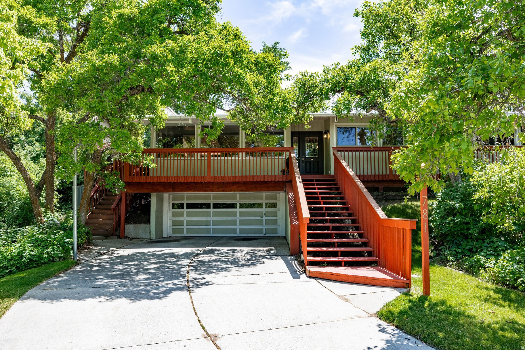 NEW TO MARKET - OPEN HOUSE SAT. JUNE 13th, 10 AM  2 PM. This unique ranch style home is nestled on a generous sized lot, slightly raised above and set back from the road for privacy. The lush green trees surrounding the home create the feel of tree house living. Upon entry you will be greeted by the open concept, main living area that features open beam wood ceilings, a stone fireplace and the inviting, renovated kitchen. A large center island, custom cherry cabinets, gleaming quartz counters and stainless appliances will appeal to the chef in the family while creating the perfect center point for gathering and entertaining. Expansive windows and sliding glass doors bring the glory of nature in to the interior and beckon you to the outside where you will spend summer on the expansive deck enjoying the mountain view, gardening in the back yard or relaxing in the hot tub. The layout of 3 bedrooms and 2 full bathrooms on the main level and an additional bedroom with bathroom on the lower allows for flexibility of use as bedrooms, home office or separate guest area. Recently new (2021) furnace and air conditioning unit. This South Ogden location is convenient to schools, shopping and commuter routes to Hill Air Force base, Salt Lake City and SLC International airport. Quick to downtown Ogden, mountain trails and both winter and summertime recreation in Ogden Valley.