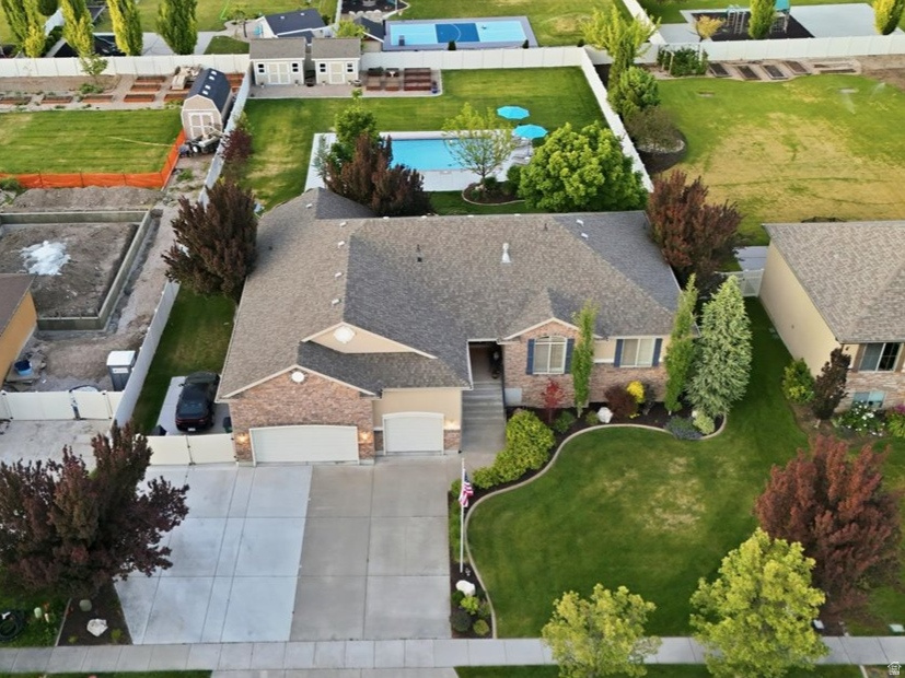 Located in the highly sought-after Sunset Equestrian Estates, this spacious 5,000 sq ft rambler offers exceptional space, entertaining areas, and an incredible backyard designed for making memories. Sitting on a beautifully maintained west-facing half-acre lot, the backyard is truly the centerpiece with a stunning new gunite saltwater pool featuring top-of-the-line equipment, a custom jumping rock with waterslide, and an almost 10-foot deep end built for summer fun.  There's still plenty of room for recreation beyond the pool, along with two spacious decks, a patio gathering area, and a natural gas fire pit ideal for roasting marshmallows or warming up after an evening swim. A hot tub is also negotiable with the sale. Two new sheds provide excellent storage, including one dedicated to housing the pool equipment.  Inside, the home features an awesome floor plan with tall ceilings, oversized rooms and a second kitchen in the basement that creates ideal space for entertaining, multi-generational living, or hosting guests. The home is in excellent condition with new paint, updated light fixtures, new built-in shelving, and a new tile backsplash. Carpet and appliances were updated in 2019, and portions of the driveway have also recently been replaced.  Additional highlights include a large 3-car garage, RV parking, and access to the outstanding Sunset Equestrian Estates amenities including two additional swimming pools, picnic areas, and tennis courts.  Come take a look today!