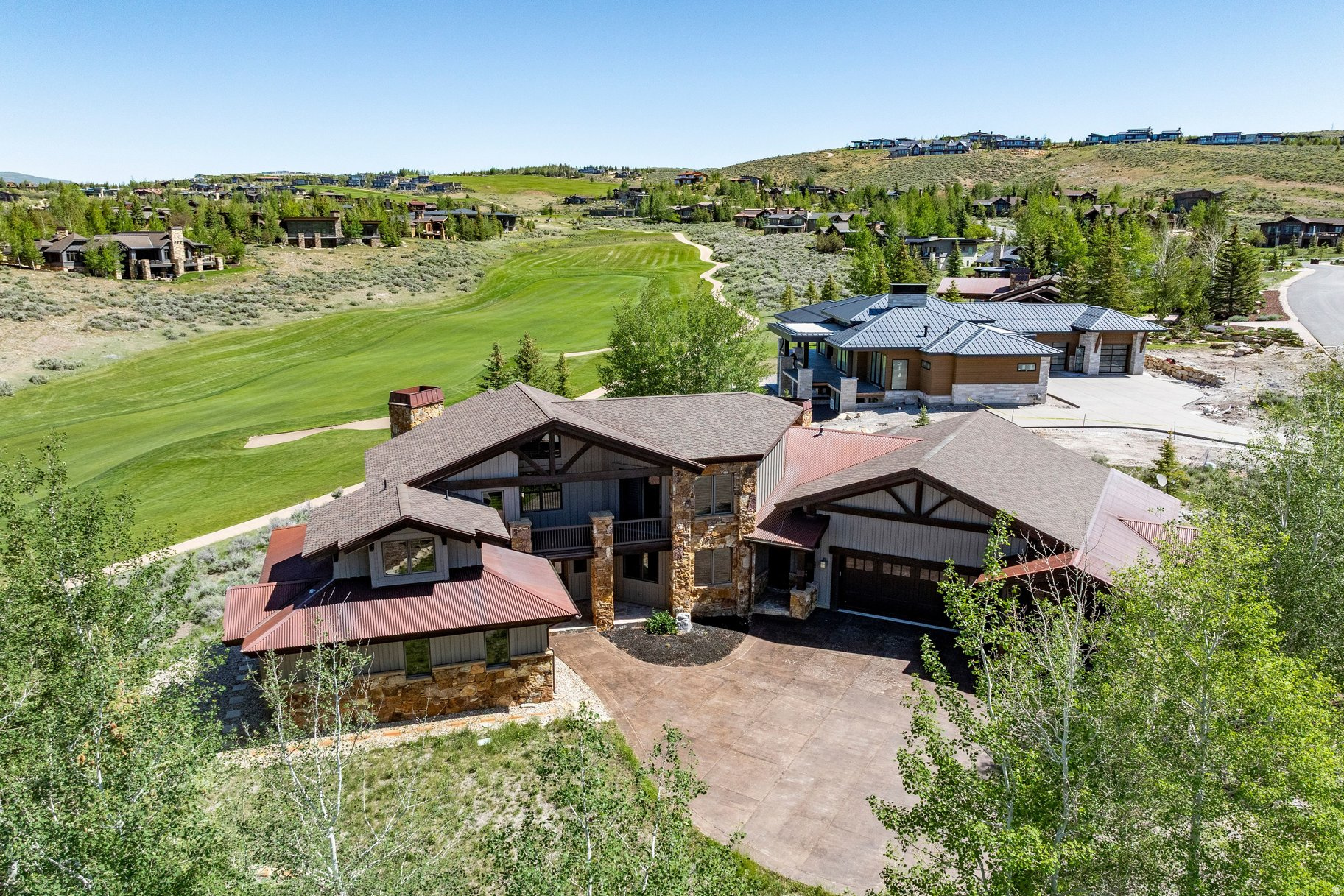 Luxury living in a highly coveted location! This home is defined by its breathtaking views - it overlooks the third hole of the renowned Pete Dye Golf Course and offers vistas of the Wasatch ski mountains. Tucked away on a serene neighborhood street, this property promises tranquility while being conveniently close to Promontory's extensive 40+ mile trail system, and the Equestrian Security gate.The open floor plan seamlessly combines natural wood and stone elements, anchored by a floor to ceiling fireplace. High tongue-in-groove ceilings add to the grandeur while large windows fill every corner with abundant sunlight. Outside, you'll find a flagstone patio perfect for entertaining or just watching the golfers pass by. A hot tub and firepit is surrounded by lush landscaping and mature trees providing natural beauty and privacy.The gourmet kitchen comes equipped with top-of-the-line Thermador appliances and features an impressive butler's pantry with a second dishwasher, wine refrigerator, and wet bar. An art studio awaits your creative endeavors, while the spacious bedrooms each have their own private bathrooms offering privacy and comfort. The main level master suite serves as a private retreat complete with a large walk-in closet, dual vanities, steam shower and a jetted tub.The oversized three-car garage has plenty of storage space, and a dedicated ski and snowboard wax room allows you to always be ready for the slopes. Promontory offers four-season amenities, including golf, tennis, pickleball, hiking, swimming pools, a beach club, and private ski lodges at Deer Valley, and Park City, available with a separate membership from the Promontory Club. Park City offers an array of amenities including world-class ski resorts, year-round outdoor activities such as hiking and mountain biking trails, cultural events like film festivals and concerts, excellent dining options, shopping venues, and more.