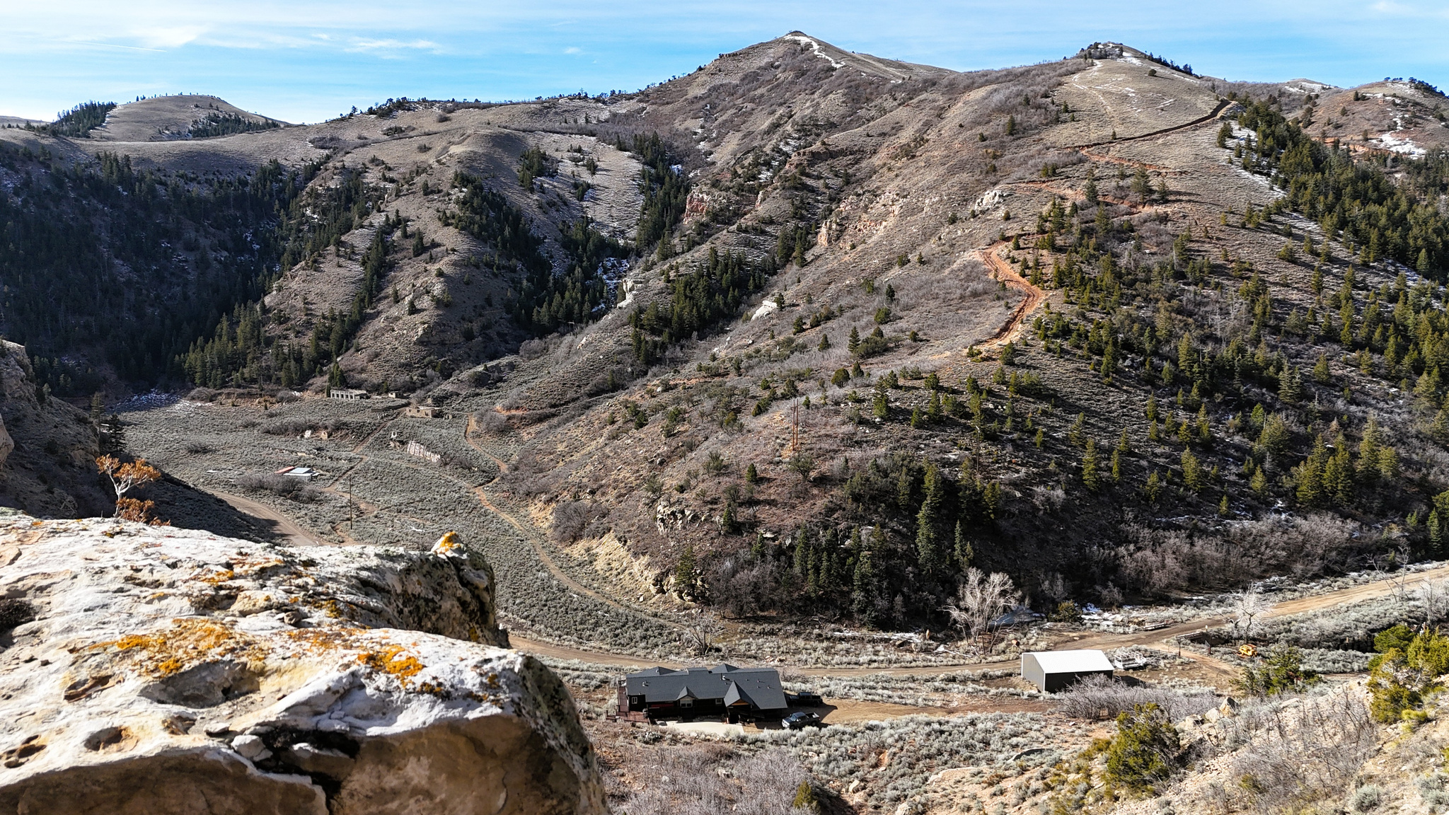 Located just outside the town of Helper, Utah, this expansive 748+ acre property offers a combination of history, recreation, and wildlife habitat within Carbon County's mountainous landscape. Known as the Ghost Town Getaway Ranch, the land contains portions of the historic Latuda and Rains mining towns. Evidence of Utah's coal country heritage remains visible across the property, with relics from a bygone era integrated into the rugged terrain.  The property has been used for recreational purposes for more than three decades, and even saw some commercial/STR use during that time as well. Hiking, hunting, camping, rock climbing, and exploring are common activities for both residents and visitors to this area.   The current owners have continued to expand road and trail access, including over 4 miles of UTV trails leading to secluded portions of the ranch. These areas are well shielded from the main road, providing privacy and a wide range of outdoor opportunities.  Multiple big game species frequent the property, and sightings of elk and mule deer are frequent in the fall and winter, while black bear, mountain lion, coyotes, and upland bird species have also been known to roam the area. The property lies within the limited-entry Manti hunting unit, recognized for quality elk and deer habitat. During the late fall and winter, large groups of elk and deer often use the property as winter range, and the property has been entitled to one buck deer, along with up to 7 cow elk tags yearly. BLM ground located immediately to the south and east connects the ranch to over 8,800 contiguous acres of additional land for recreational purposes.  A key feature of the property is a substantial log-style cabin built in 1995. The residence measures more than 4,000 square feet and includes 8 bedrooms and 9 bathrooms. The cabin is designed for group use, with a large great room, wrap-around porch, covered parking, and multiple walk-in showers. A sauna adds another element for extended stays. With a separate guest entrance, the home is flexible for family gatherings, group retreats, or potential short-term rental use.  Utilities and water resources enhance the property's usability. The ranch includes water rights sufficient for multiple cabins and the capacity for agricultural use, focused on livestock. The location on Spring Canyon Road provides reliable, county-maintained access directly to the cabin, ensuring year-round entry.  The varied terrain of the ranch offers dramatic elevation changes, scenic viewpoints, and secluded canyons. These features make the property suitable for multiple outdoor pursuits while also highlighting its unique natural beauty. The combination of history, access, water resources, and wildlife use distinguishes this property as one of significant recreational and conservation value.  Helper is located just minutes from the property, offering essential services and supplies. Price, Utah, is approximately 15 miles to the southeast, providing additional amenities, shopping, and medical facilities. Salt Lake City lies about 120 miles to the northwest, making the property accessible from Utah's largest metropolitan area within a reasonable drive.  For those seeking a large-acreage property with recreational, historical, and residential elements, this Carbon County ranch offers a rare opportunity. Its unique combination of features and location ensures a wide range of potential uses, from private retreats and hunting land to agricultural operations and historical exploration.  Also listed as 2140143 (land)