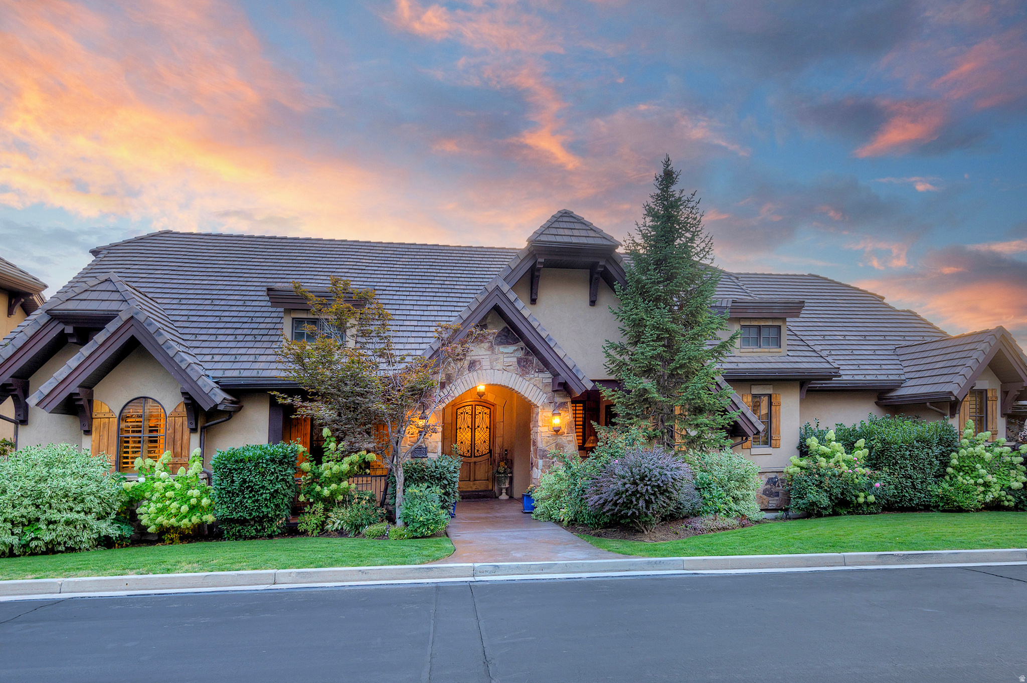 Welcome to Falcon Cove-an exclusive gated community perched high on the Cottonwood Heights east bench-where this exceptional estate is set against the backdrop of Little Cottonwood Creek gently flowing adjacent to the backyard, creating a rare and serene waterfront setting, with full main floor living for those seeking comfort and convenience without compromise. Enjoy the peaceful sights and sounds of nature from your private walkway leading down to the stream-a truly charming retreat that sets this home apart. This refined estate offers 5,821 sq ft, 4 bedrooms, and 5 bathrooms, with soaring ceilings, rich hardwood floors, and a beautiful fireplace that sets the tone the moment you enter. Thoughtfully enhanced with a newer HVAC system (within 5 years), dual hot water heaters, and a whole-house scent system, the home blends comfort with elevated luxury. Designed for effortless living and entertaining, the home features a second kitchen, a movie theater, a spacious walkout lower level, and exceptional storage throughout. The upgraded Control4 home automation system-complete with new switches, amp, and in-ceiling speakers-offers seamless control of lighting, audio, and more. Multiple outdoor living spaces, including a deck with electric patio blinds, allow you to fully take in the tranquil creekside setting year-round. Professional landscape lighting beautifully illuminates the grounds at night, and custom-fitted Christmas lights (stored in the basement) make holiday decorating effortless. Recent roof upgrades and inspections add peace of mind. The gourmet kitchen showcases custom cabinetry, a massive island, and an open layout ideal for gatherings. The luxurious primary suite includes a spa-like bath with a jetted tub and separate shower. Set on a manicured .32-acre cul-de-sac lot with a 3-car garage, this home is minutes from four world-class ski resorts-including Snowbird and Alta-and close to fantastic restaurants, offering the ultimate blend of mountain adventure and everyday convenience. Quick access to Salt Lake International Airport completes the perfect location. Offered fully furnished-including artwork, dcor, kitchenware, and linens-this is a true turnkey opportunity... just bring your toothbrush. A rare opportunity to own a true creekside retreat along Little Cottonwood Creek in one of Cottonwood Heights' most coveted gated communities.