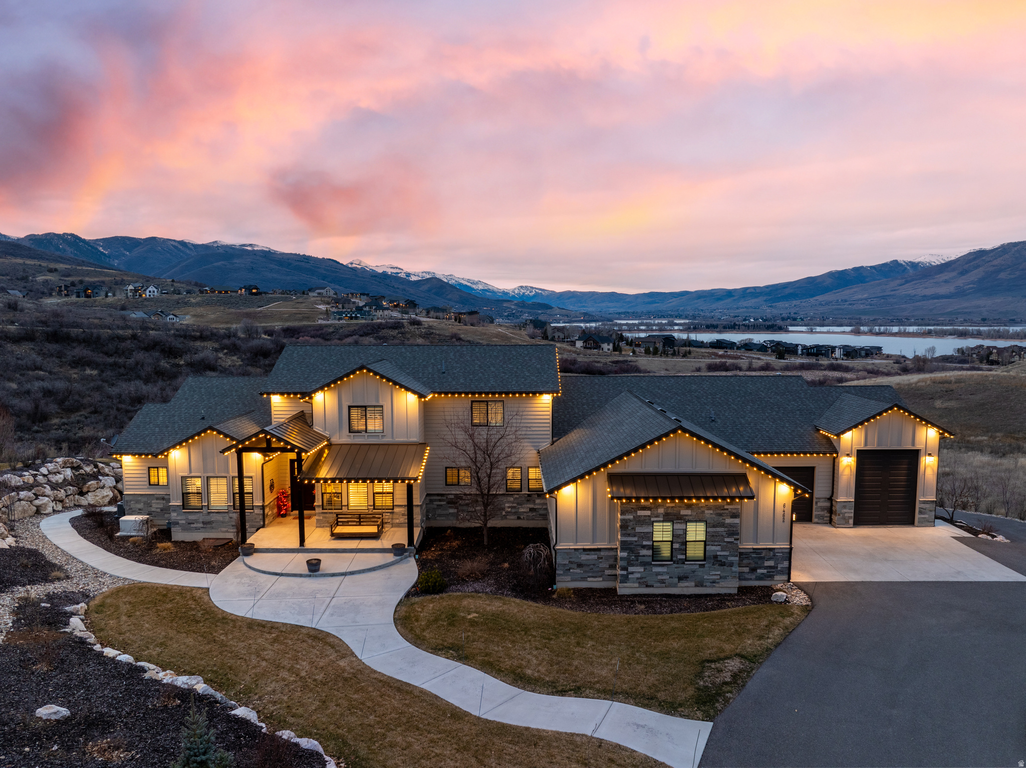 Set on over an acre inside the gated Ski Lake community, this 8-bedroom, 7-bathroom mountain estate delivers sweeping lake and mountain views and a lifestyle most people only dream about. The main level is built to live in, not just look at. A vaulted great room anchored by a floor-to-ceiling stone fireplace, a gourmet kitchen with quartz finishes and seating for seven, and a dining area that opens to a view deck with a built-in grill. The primary suite is exactly what it should be: spa bath, soaking tub, dual vanities, custom walk-in closet. You'll also find a walk-in pantry, mudroom, laundry room, and because someone had the right idea, a built-in slide to the backyard. Upstairs adds two more bedrooms and a full bath. Head down to the walk-out lower level and things get serious: 10-foot ceilings, a second family room, kitchenette, bunk room, three additional bedrooms, and an indoor basketball/pickleball court. There's also a fitness room, second laundry, playroom with a foam pit and rock wall, and a home theater with a 150" screen and star ceiling. Outside you'll find heated garages, RV parking, garden beds, a playground, and an in-ground trampoline. The home runs on an automated generator and includes a water softener and custom shutters throughout. World-class skiing, hiking, and biking are minutes away. Properties like this don't come around often, and when they do, they don't last. All property information, boundaries, and documents to be verified by buyer.