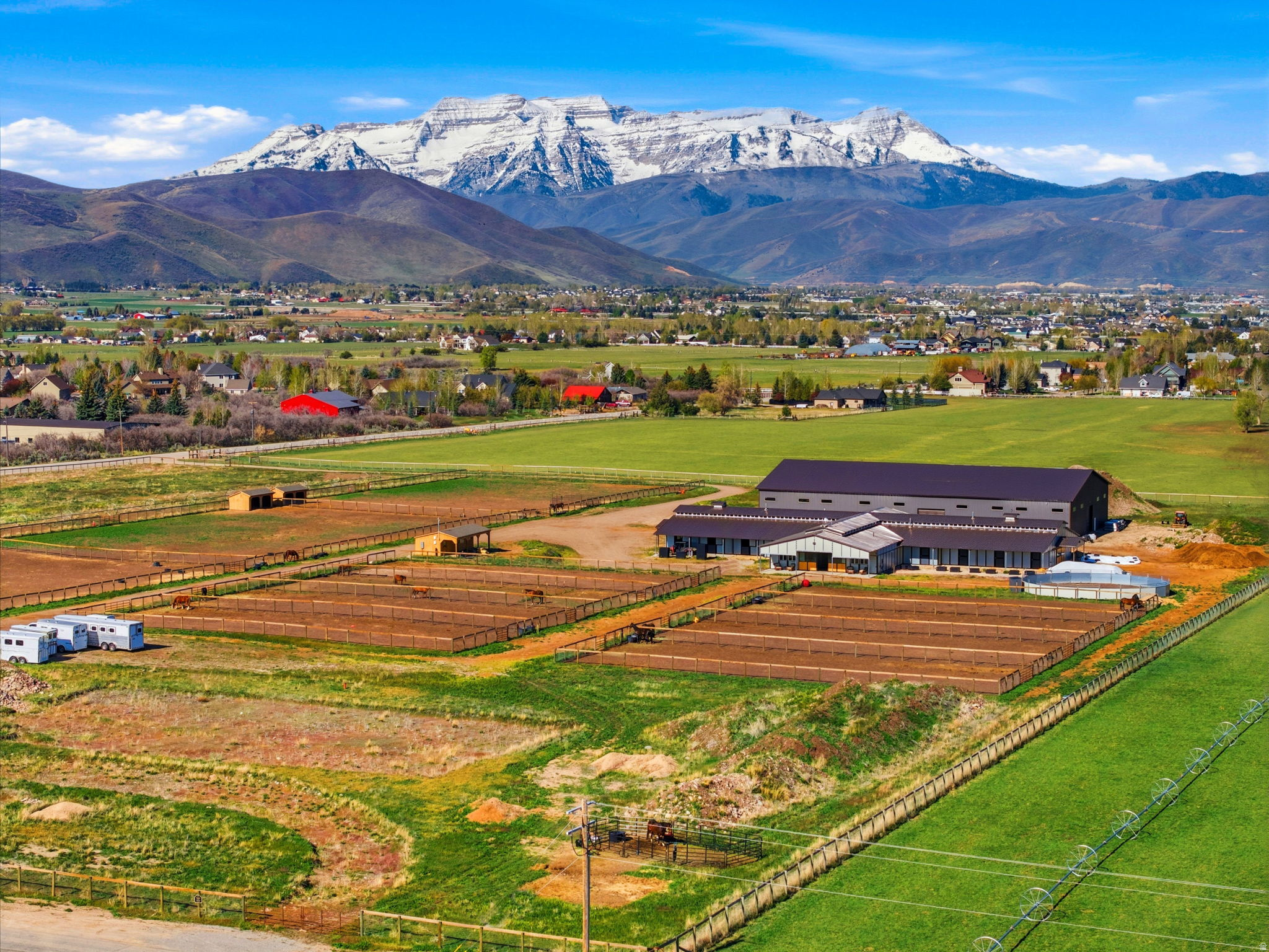 Set across 10 pristine acres in the heart of the Heber Valley, Medallion Ranch represents one of the most refined private equestrian estates currently offered in Northern Utah. Thoughtfully designed for serious horse enthusiasts while offering exceptional long-term development flexibility, the property consists of one 10-acre parcel. The parcel is fully improved, with a newly completed world-class equestrian facility, including a custom MD Barnmaster 16-stall raised-aisle 9,400-square-foot barn and a 13,760-square-foot indoor riding arena, both completed in 2024. Positioned to capture unobstructed 360-degree mountain views, including Mount Timpanogos and the Wasatch Range, this estate offers rare usability, privacy within minutes of Deer Valley East Village, Midway, and Park City. Equestrian Facilities: The barn was constructed by MD Barnmaster, a nationally recognized leader in premium equestrian structures. Features include Kick-Proof steel-lined walls, zero-fire-spread materials, heated aisles, two tack rooms, wash bays with hot/cold water, lounge, office, laundry, mechanical room, LED lighting, fans, electrical at each stall, heated automatic waterers, and remote camera monitoring. The indoor arena, completed by Roper Buildings, features 2" spray foam insulation, maximum window exposure for natural light, premium arena paneling, exceptional sub-base and footing installation, LED lighting, and remote camera access. A large pad west of the arena allows for future outdoor arena expansion. The property offers exceptional access: 1015 minutes to Deer Valley East Village, Midway, Deer Creek & Jordanelle Reservoir, 20 minutes to Park City & Sundance, 35 minutes to Salt Lake City, and 45 minutes to Salt Lake City International Airport. The surrounding region offers world-class skiing, blue-ribbon fly fishing, championship golf, boating, hiking, biking, and year-round equestrian recreation. Investment & Legacy Opportunity: Medallion Ranch is more than an equestrian estate. It is a legacy-quality property with infrastructure already in place and an adjacent 10-acre parcel available for separate purchase, offering future upside. Whether utilized as a private equestrian compound, developed into a signature estate, or expanded into a generational ranch retreat, the combination of completed facilities, architectural vision, land flexibility, and proximity to world-class resorts makes this offering exceptionally rare. Full architectural plans by Clayton Vance Architecture, recognized on Forbes' Best-in-State list of America's top architects, are available for an approximately 11,000 square-foot modern farmhouse estate home sited above the equestrian facilities to preserve uninterrupted mountain views. Lot lines are approximate drawings for visualization; buyer is to verify.