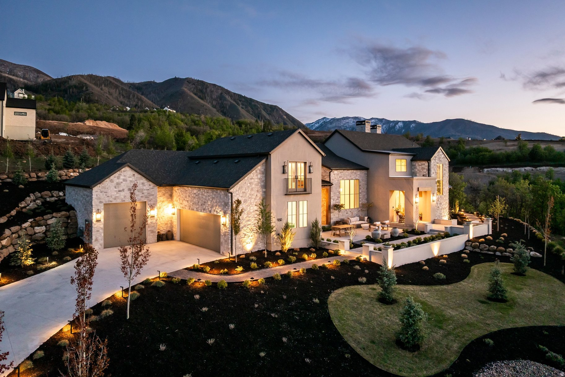 Designed by the award-winning Design Loves Detail and set within Summit Creek's private gated community, this one-of-a-kind custom home delivers 8,400 sq ft of intentional luxury on nearly an acre with sweeping views of Utah Lake, the valley, and the Wasatch Range in every direction.  The main floor opens with vaulted ceilings, floor-to-ceiling windows, and a seamless indoor-outdoor flow anchored by a quartzite kitchen, butler's pantry, and mudroom. The primary suite is its own wing, impeccably finished and quietly removed from the rest of the home. A second main-floor bedroom serves perfectly as a nursery, guest suite or office.  Upstairs, three bedrooms and a loft homework area keep the family spread out without feeling disconnected. The fully finished basement adds two more bedrooms, a home theater, rec room, second kitchen, gym, and laundry. Above the three-car garage, a private mother-in-law apartment with its own entrance adds flexibility that few homes at this price point can match.  Outside, a covered patio, in-ground stainless steel hot tub, and mature landscaping wrap around the home and are designed for entertaining. The whole-home generator, EV charging, and top-tier water filtration system mean nothing has been left to afterthought. Summit Creek HOA amenities include a resort-style pool, clubhouse, pickleball courts, fitness center, and on-site security. A curated furniture and dcor package of pieces selected specifically for this home is negotiable.