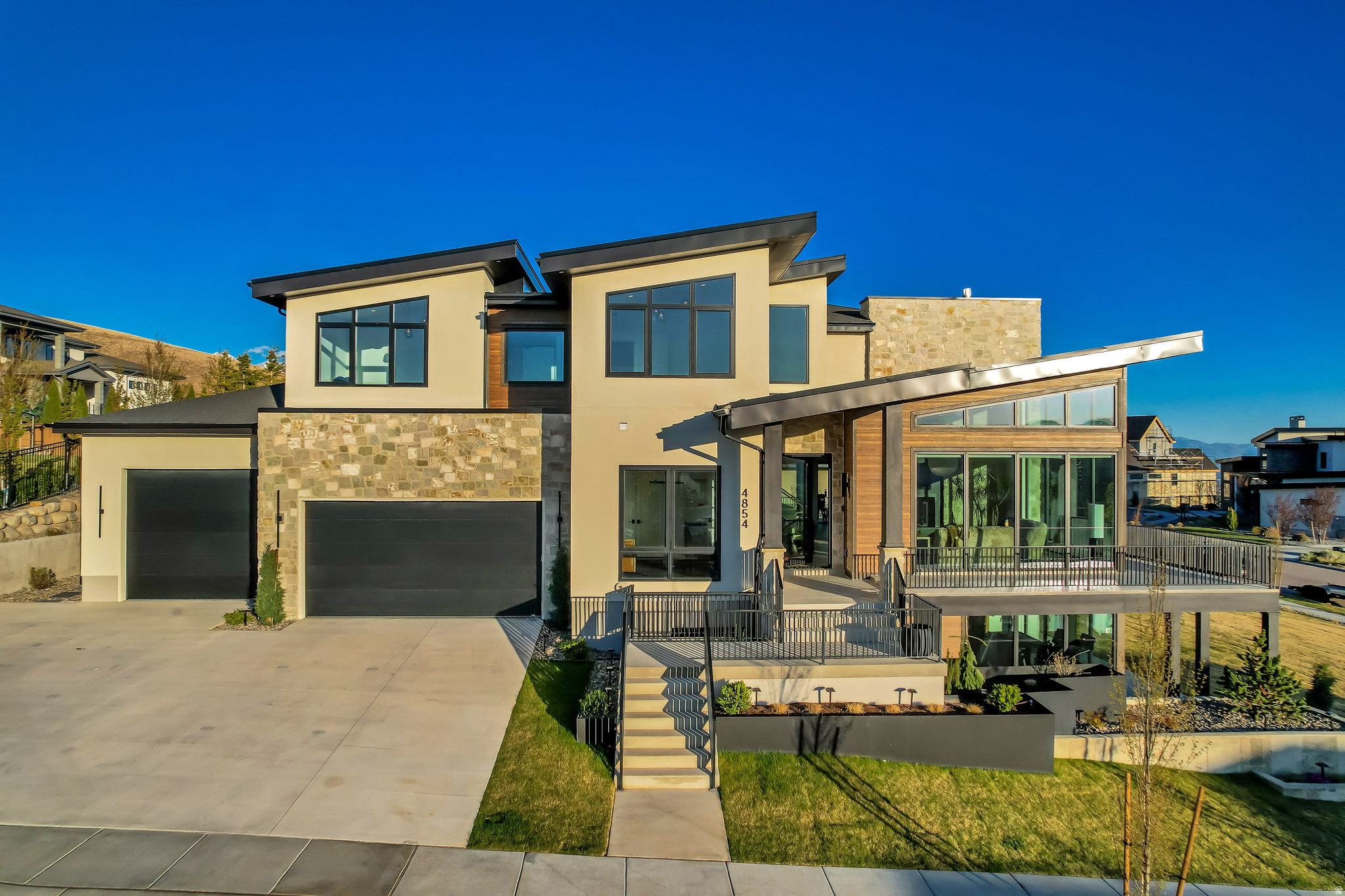 This home is one that delivers on every level. Recently completed in 2025, this newly built residence blends thoughtful design with everyday livability, featuring expansive windows that flood the home with natural light and frame the surrounding scenery from nearly every room. The main living spaces are open and inviting, anchored by seamless indoor-outdoor flow to an expansive deck that wraps around the home, perfect for entertaining or simply taking in the 360 Mountain, Lake, & Valley views. The Primary bedroom offers a private deck, fireplace, a large custom walk in closet with direct access to the laundry room. An oversized garage provides ample space and storage for all your vehicles, and toys. Designed with lifestyle in mind, the walk-out basement also includes a dedicated theater, wet bar, a fully equipped gym, and a wellness center with sauna and cold plunge. Creating a true in-home experience. Outside, a beautifully designed fire pit area sets the tone for relaxed evenings and gathering with guests. With clean lines, intentional design, and standout features throughout, this home checks all the boxes and then some. Buyer/Buyer's Agent to verify all information.